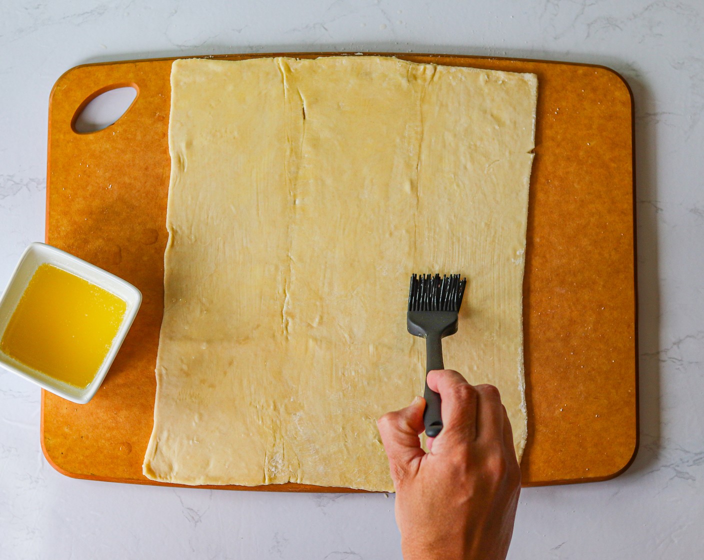 step 3 Brush the Butter (1/2 cup) onto the puff pastry sheets.