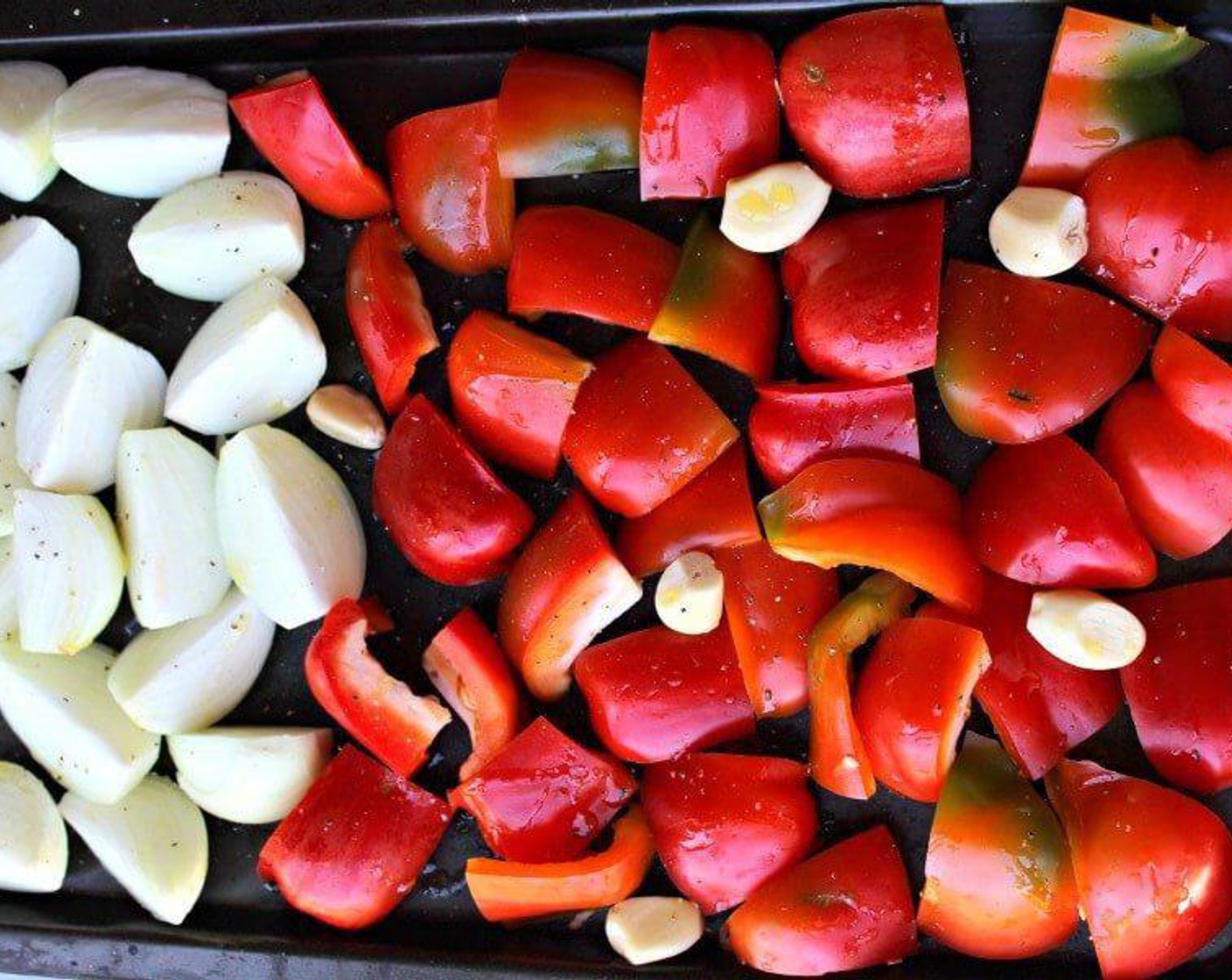 step 2 Place the Red Chili Peppers (3), Onions (4), and Garlic (6 cloves) on a large roasting pan and drizzle with about Olive Oil (3 Tbsp), toss the vegetables and season with a little Salt (to taste) and Ground Black Pepper (to taste).