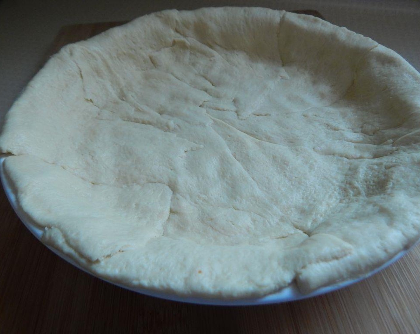 step 3 Open your Pillsbury™ Reduced Fat Crescent Rolls (1 pckg) and lay them out in your pie dish to form a pie crust. This will involve a little trimming and moving pieces around to get all the dough into a pie crust shape.