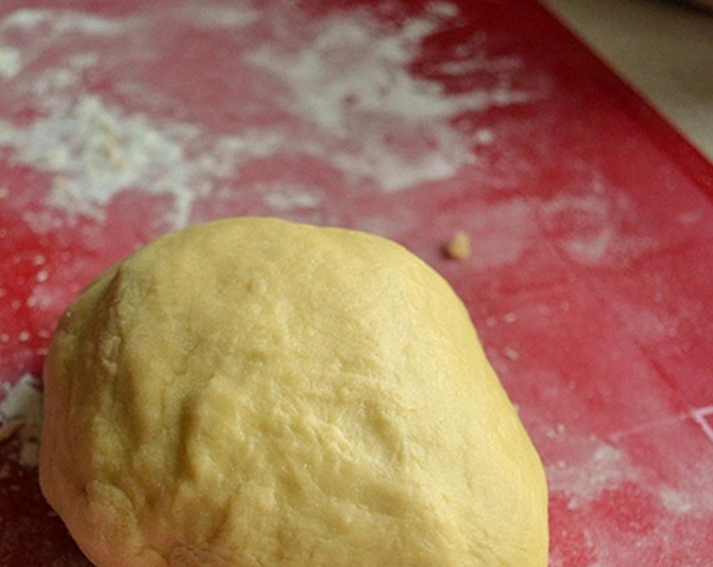 step 3 Transfer the ball of dough to a floured surface and start kneading it. Pull it, stretch it, pound it. Knead for 15 minutes or until not sticky and shiny.