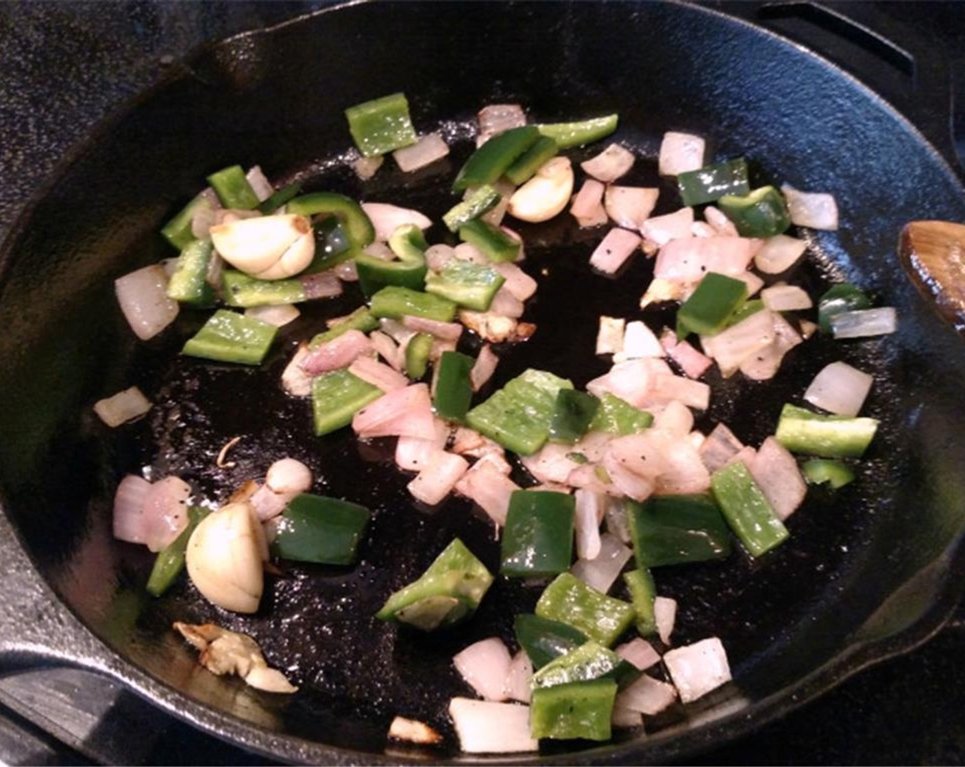 step 3 While your steak is enjoying its spa experience, saute the whole Garlic (4 cloves), Red Onion (1/2), and Poblano Pepper (1/2) in a cast-iron skillet with a bit of Extra-Virgin Olive Oil (as needed). Don’t clean your skillet just yet, set it aside.
