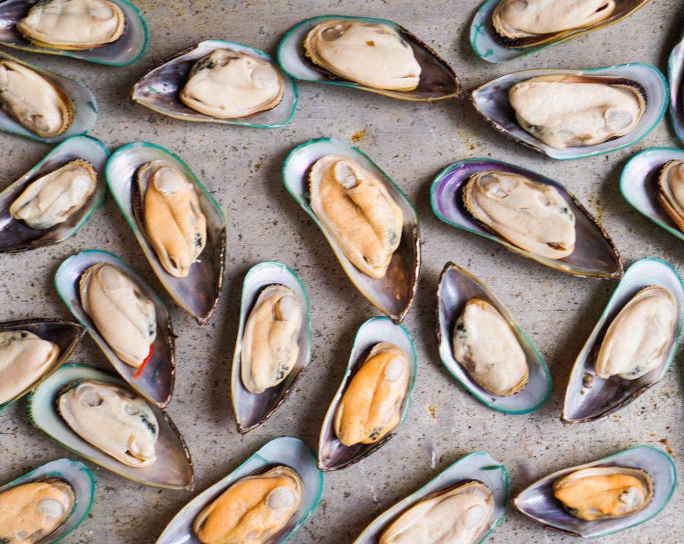 step 4 Remove the empty shell and discard. Using your fingers or a fork, wiggle the mussel out of the shell it is nestled in. You will have to break the mussel from the shell, so put a little umph in it. Lay the mussel back into the shell and arrange on baking sheet.