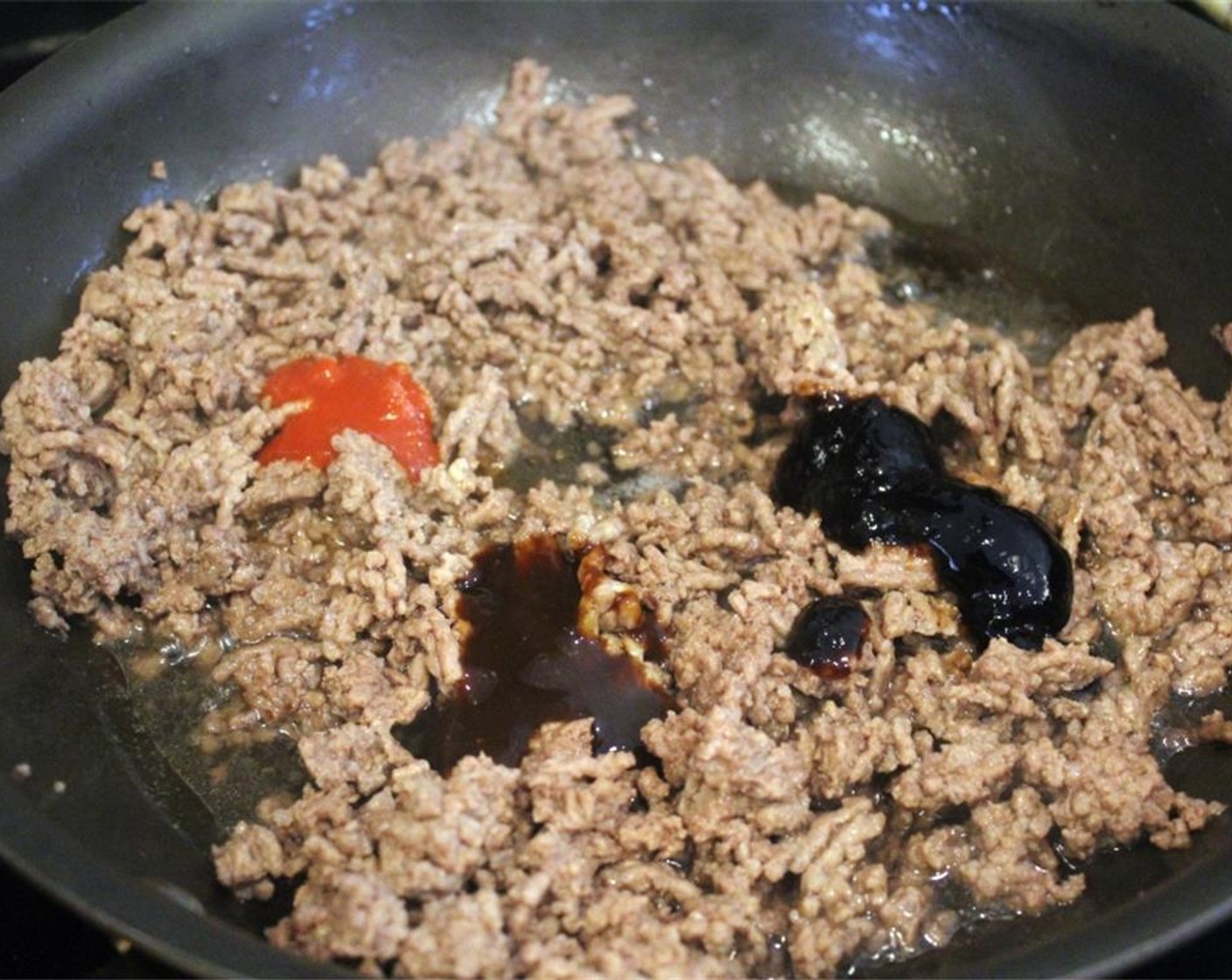 step 2 After the meat begins to brown, add the Hoisin Sauce (1 Tbsp), Oyster Sauce (1 Tbsp), and Sriracha (1 tsp).
