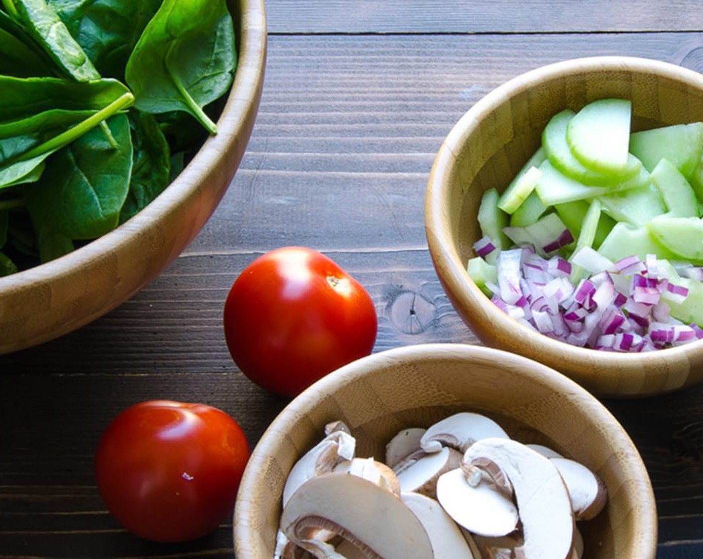 step 4 Add Fresh Baby Spinach (11 1/3 cups), thinly sliced Red Onion (1/3 cup), thinly sliced Mushrooms (8), Campari Tomatoes (4) and Cucumber (1) that is peeled, seeded and sliced into half moons. Peel the hard-boiled eggs and slice them into quarters. Set aside.