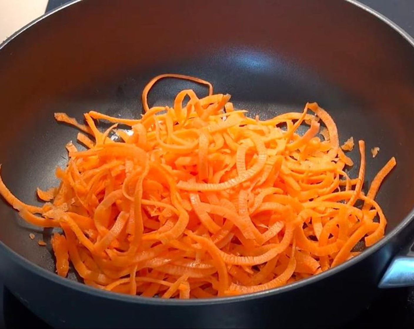 step 3 Pour some oil into a frying pan and add Ground Cumin (1/4 tsp). Put in the spiralized carrots and cook them while stirring until they start to soften.