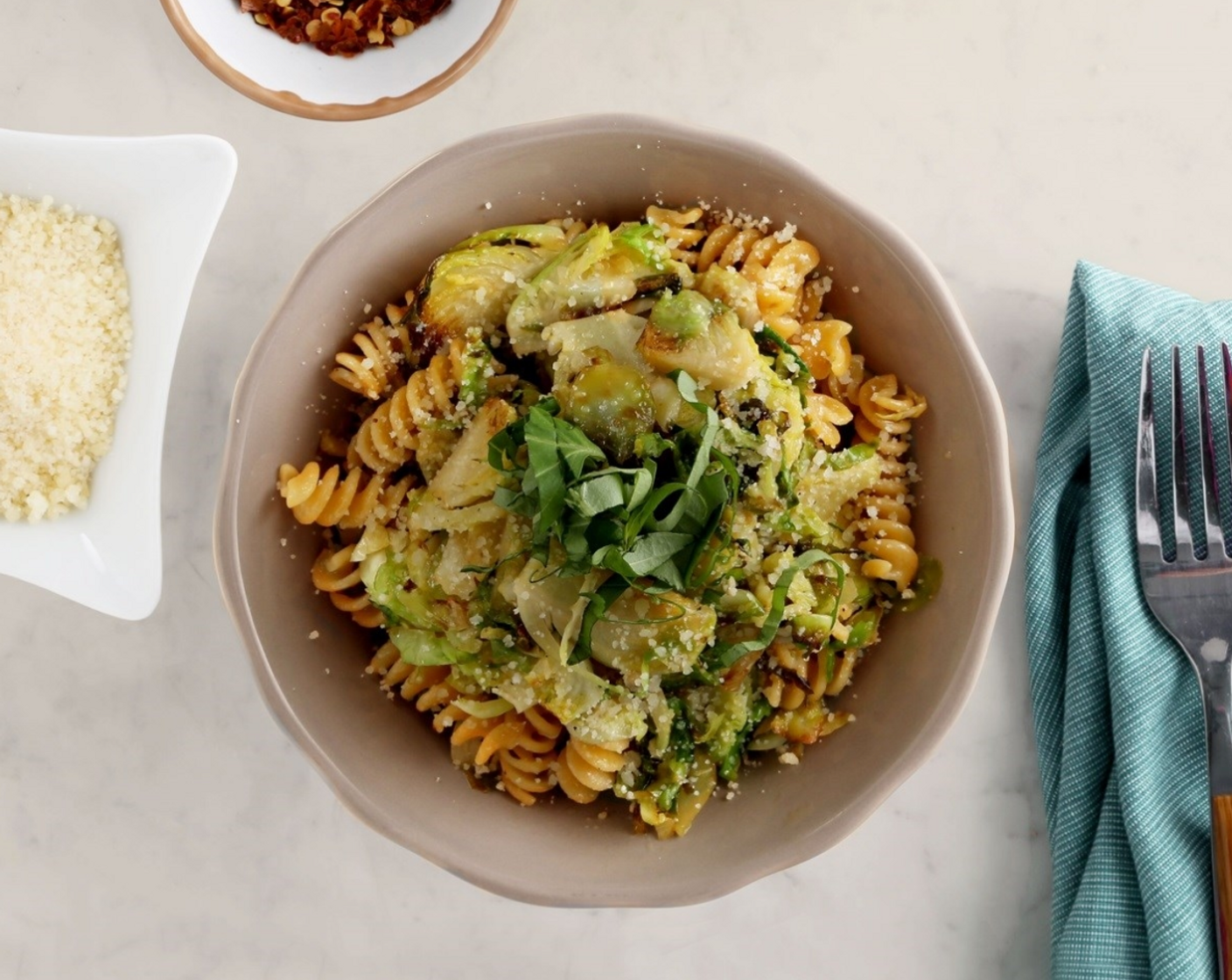 step 5 Remove from the heat. Toss pasta and Brussels sprout mixture with Parmigiano-Reggiano (1/4 cup) and top with Fresh Basil (1 Tbsp).