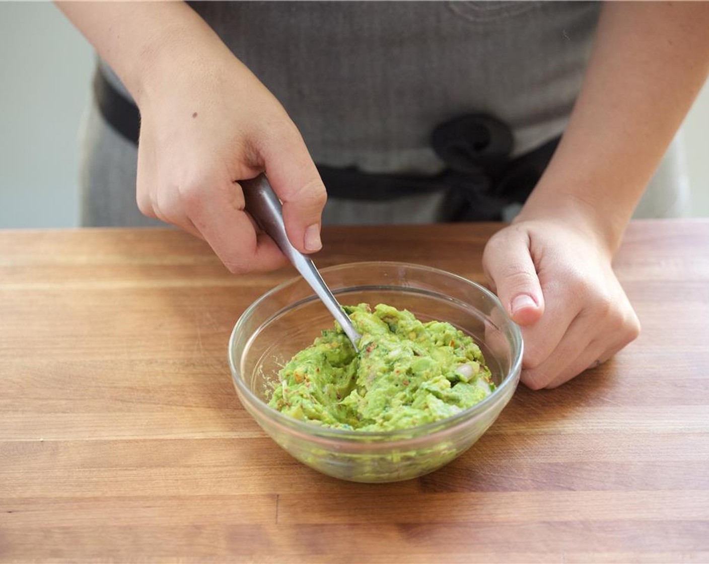 step 4 Cut Avocado (1) in half, remove the pit, and scrape out flesh into a small bowl. Add shallots, Crushed Red Pepper Flakes (1 tsp), 2 teaspoons of lime juice, Salt (1/4 tsp) and Ground Black Pepper (1/4 tsp) and half of the cilantro. Use a fork to mix well.