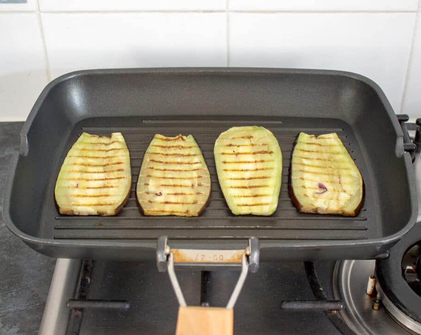 step 3 If adding Eggplant (1), heat a griddle pan over medium to high heat. Brush both sides of each slice with Olive Oil (as needed) and grill on each side until nice charred lines appear. When cooked, take out the pan and sprinkle with a little salt.