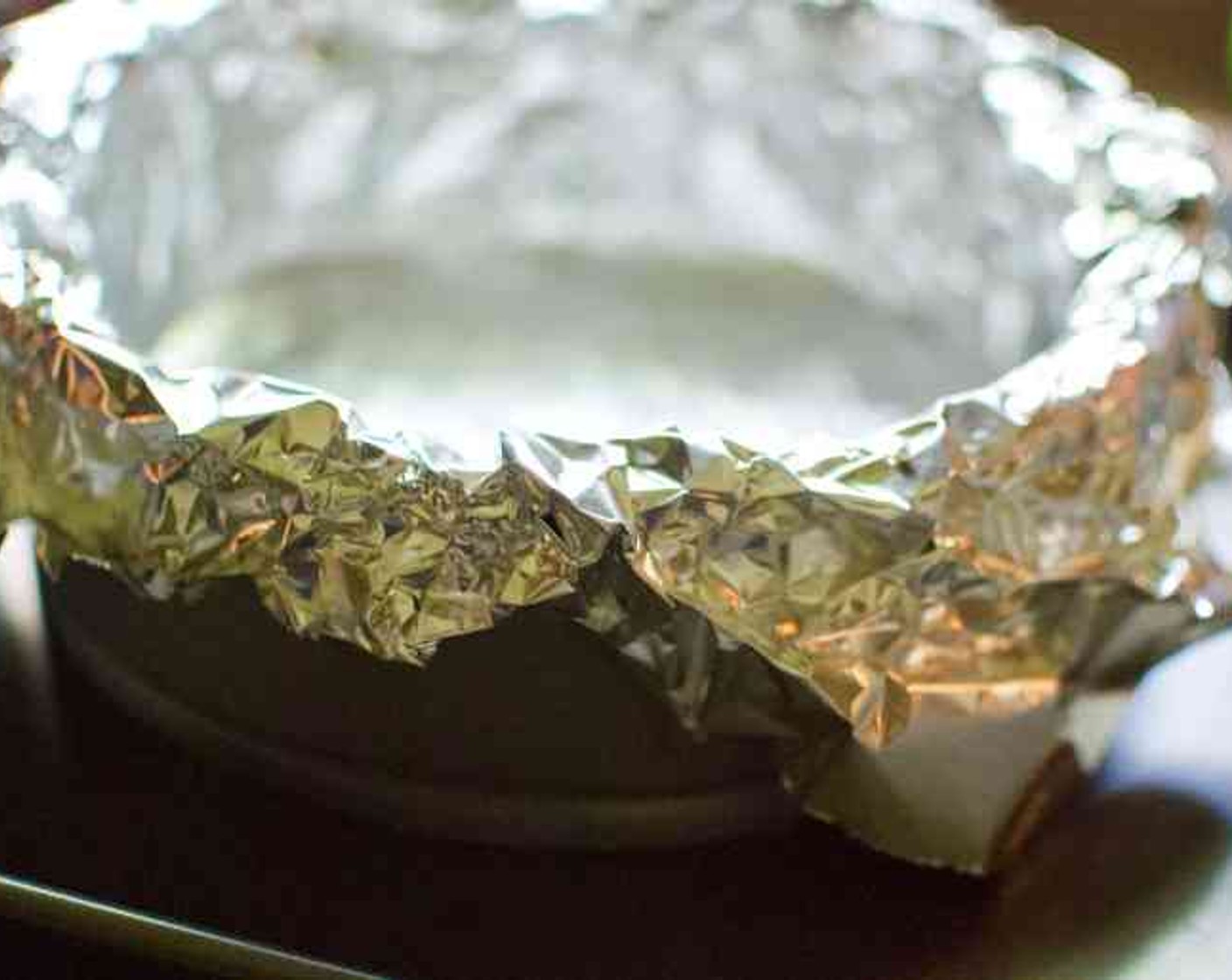 step 6 Preheat the oven to 400 degrees F (200 degrees C). Place the springform pan on a baking sheet. Line the pastry shell with a double thickness of aluminum foil long enough to overhang the sides.