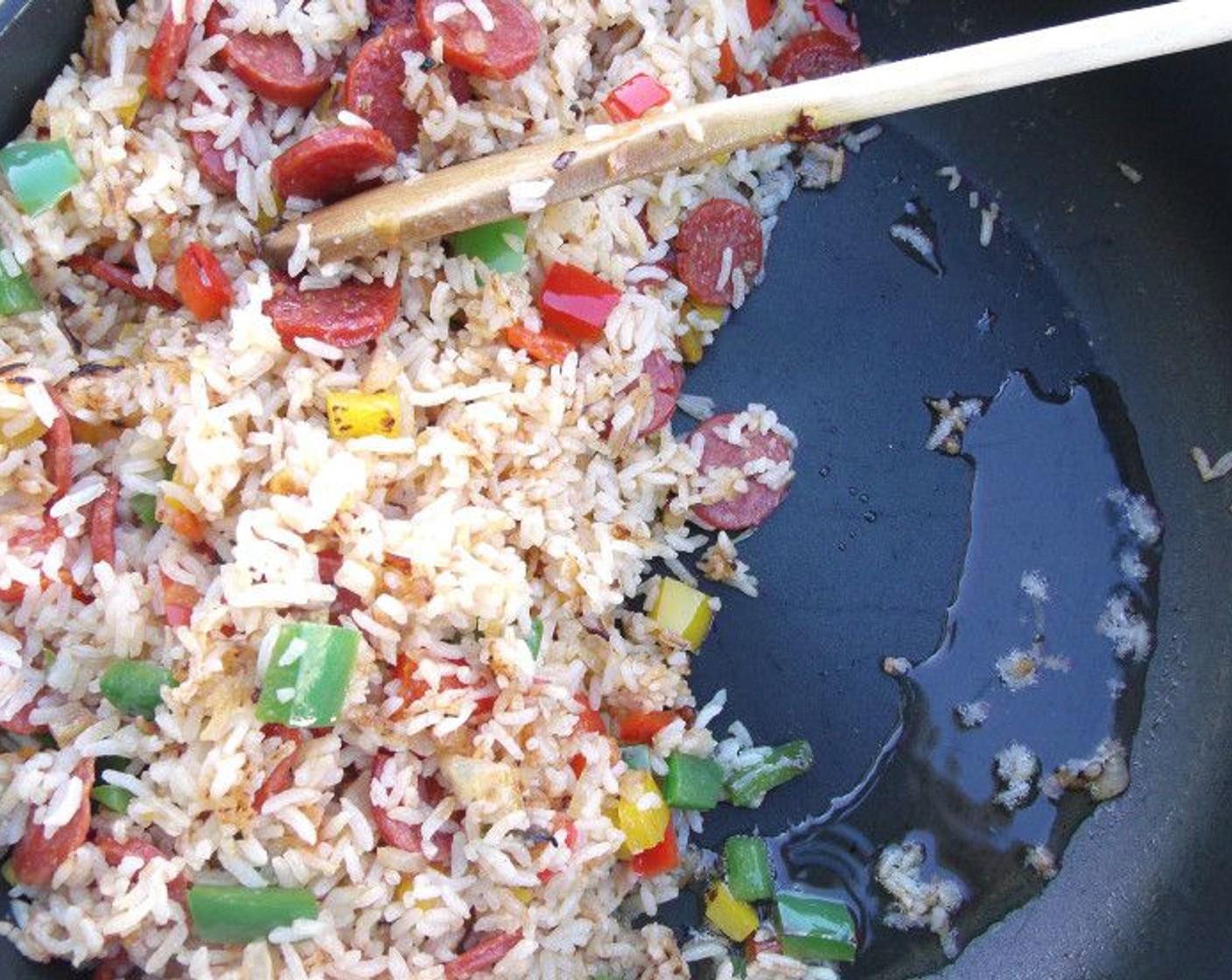 step 8 Saute until the rice “pops," then move the rice to one side of the pan and add Olive Oil (2 Tbsp). Scramble Eggs (4) until set.