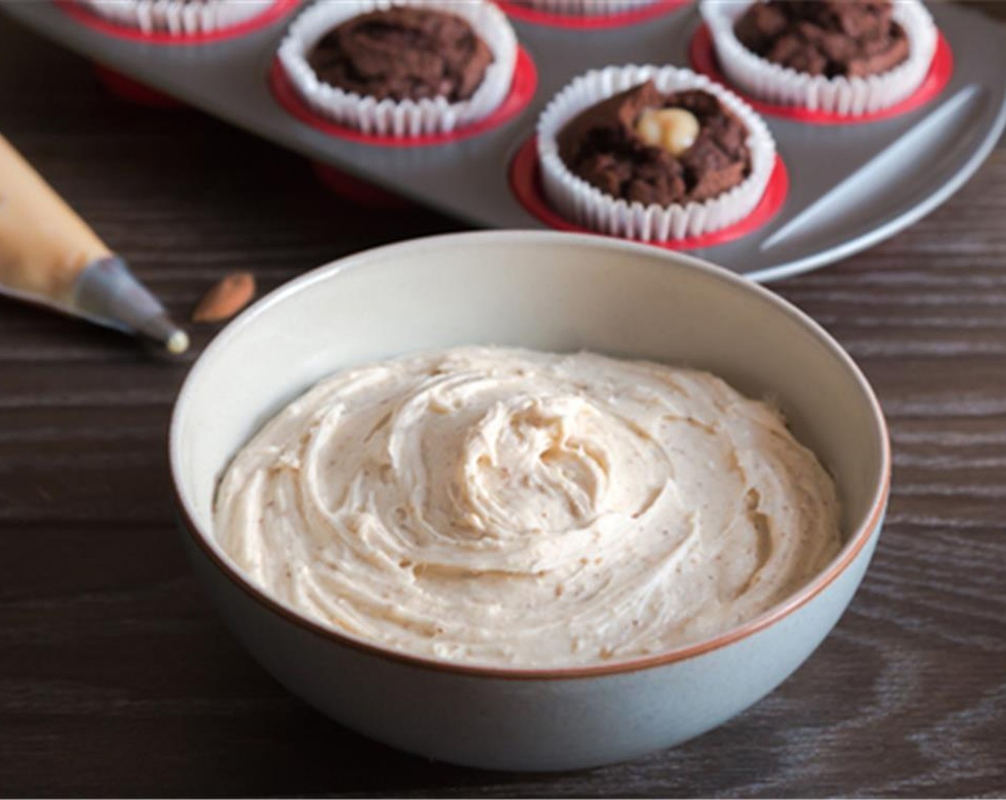 step 6 To make the frosting, use an electric whisk to slowly beat together Unsalted Butter (1 cup), Powdered Confectioners Sugar (4 1/2 cups) and Whole Milk (3 Tbsp) until smooth and fluffy. Then add the Amlou (1/2 cup) and gently combine with the frosting.