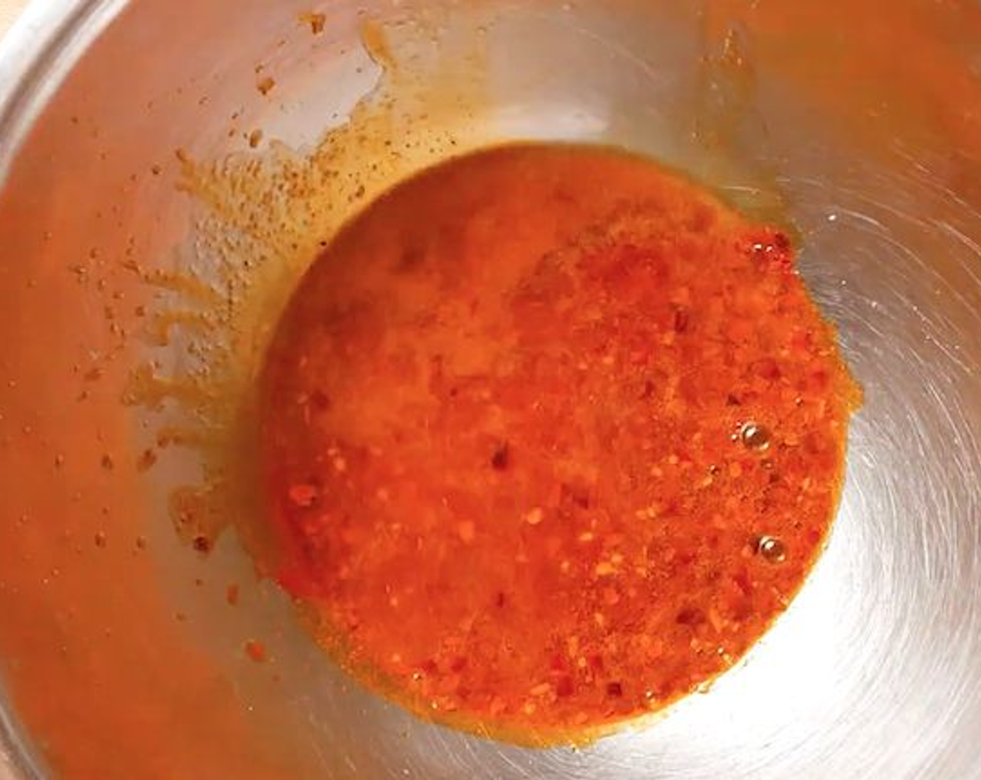 step 4 Place Sriracha Seasoning (1 cup) in a bowl and pour 1 cup of hot frying oil all over the spices.