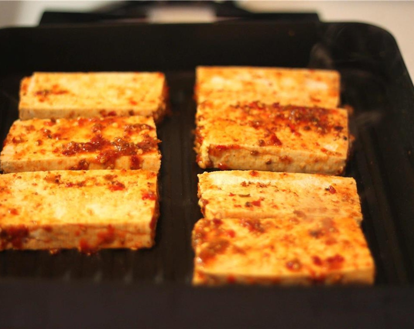 step 11 Sear each slab of tofu, about 4 minutes on each side saving any remaining marinade in the bowl.