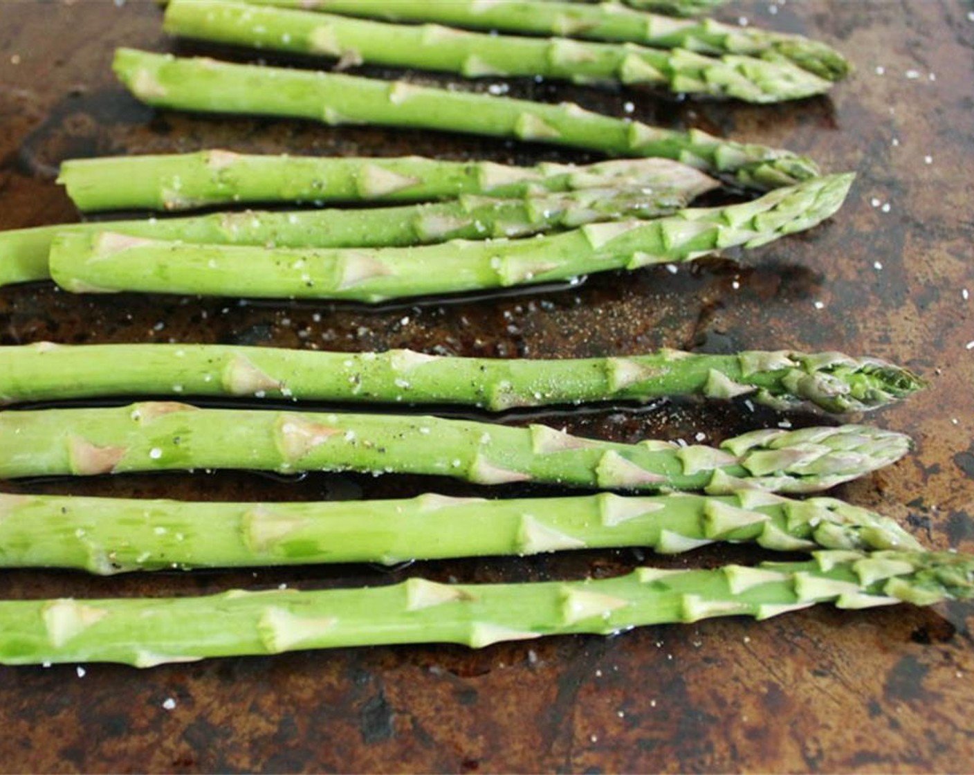 step 6 Place the asparagus on a rimmed baking sheet and drizzle with Extra-Virgin Olive Oil (1 Tbsp). Season with a little Salt (to taste) and Freshly Ground Black Pepper (to taste), and toss to coat.