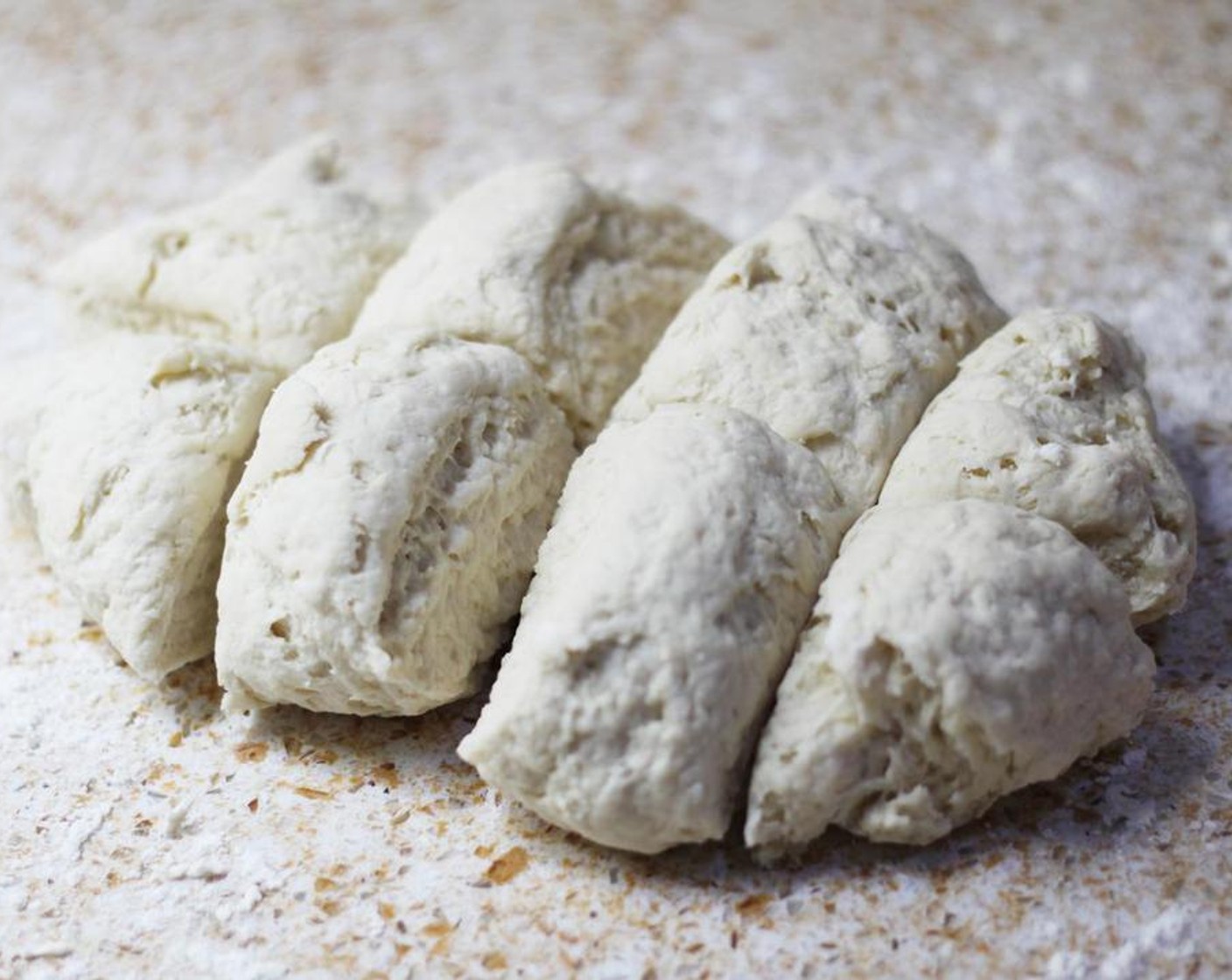 step 5 Lightly flour a surface and knead dough for a minute to bring dough together. Divide into 8 pieces.