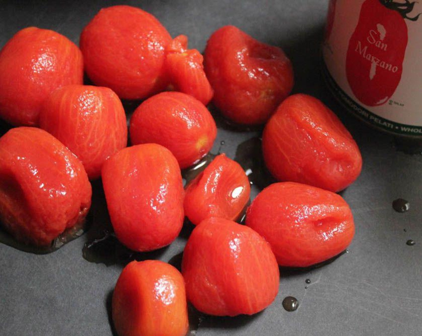 step 2 Drain the Whole Peeled Plum Tomatoes (2 cans) and reserve the liquid. Halve each tomato lengthwise.