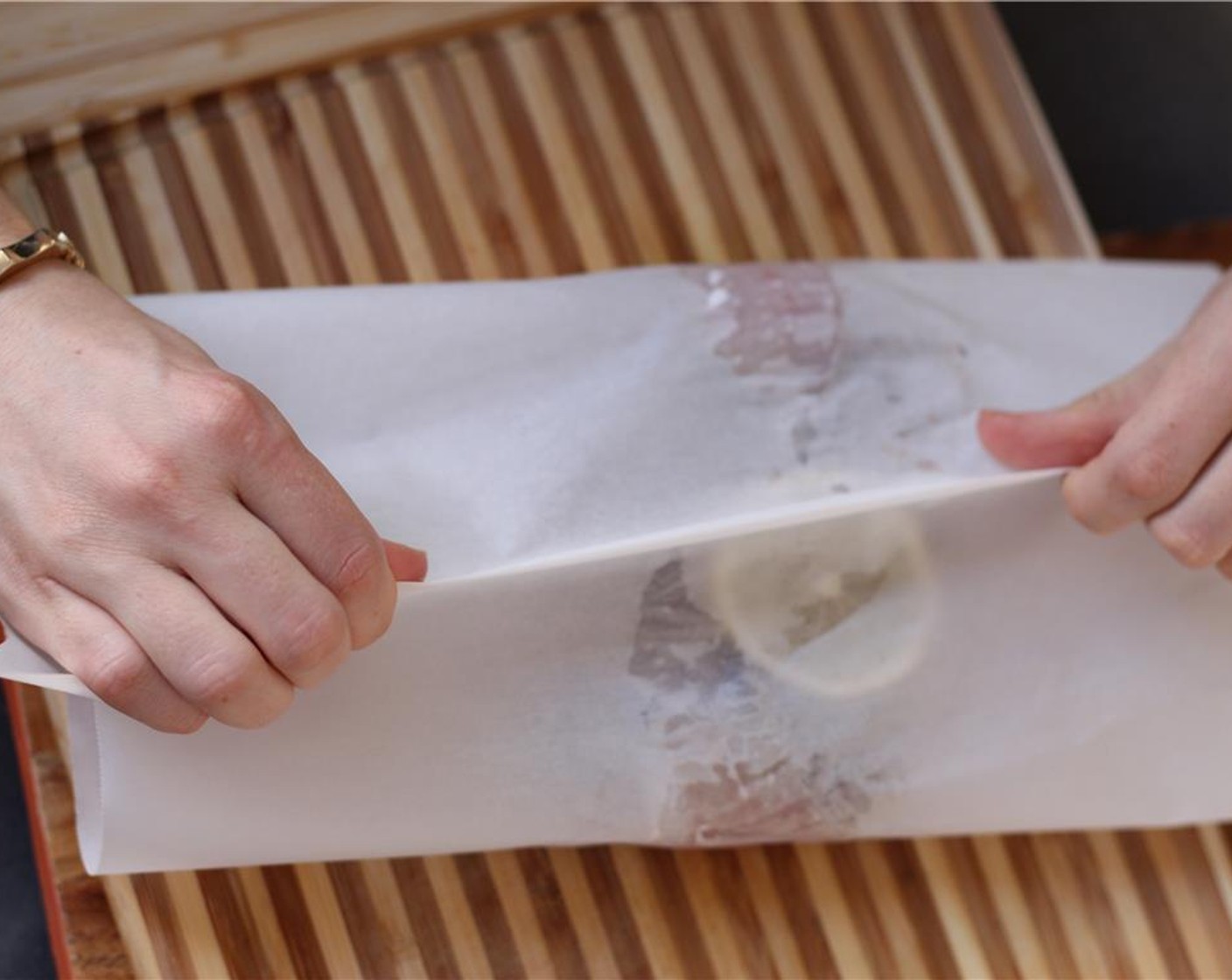 step 7 Seal the parchment by first gathering the two sides together in the center.