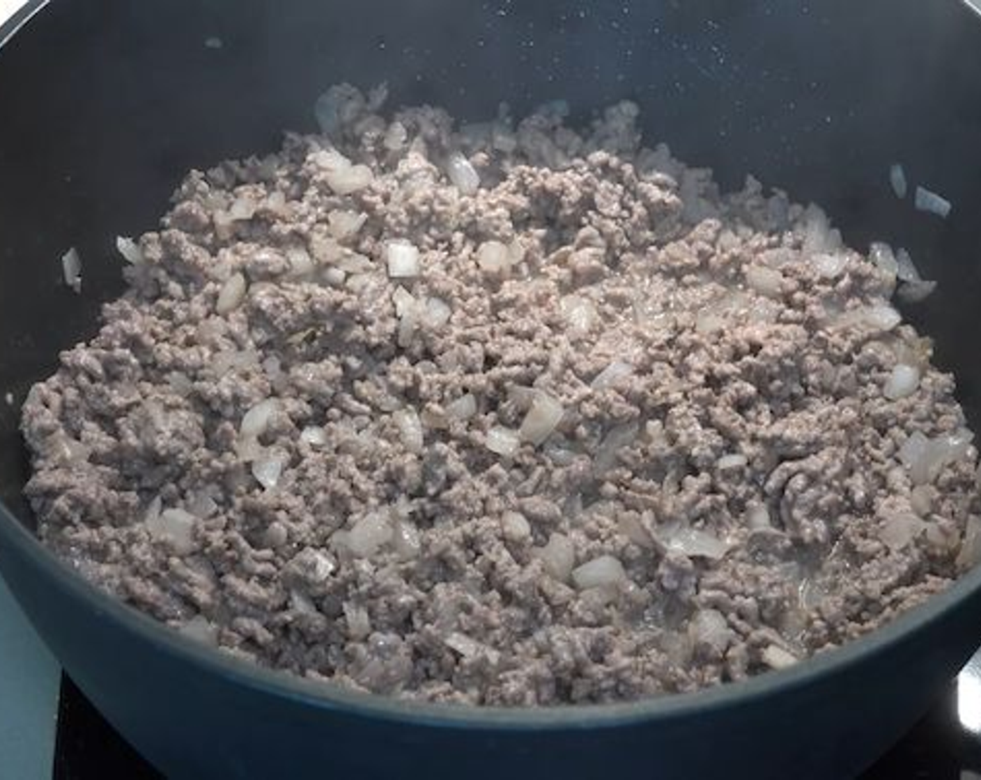 step 2 Next add in the Ground Beef (2.2 lb) and break it down using a wooden spoon. Cook for about 5 minutes or until the meat has browned.