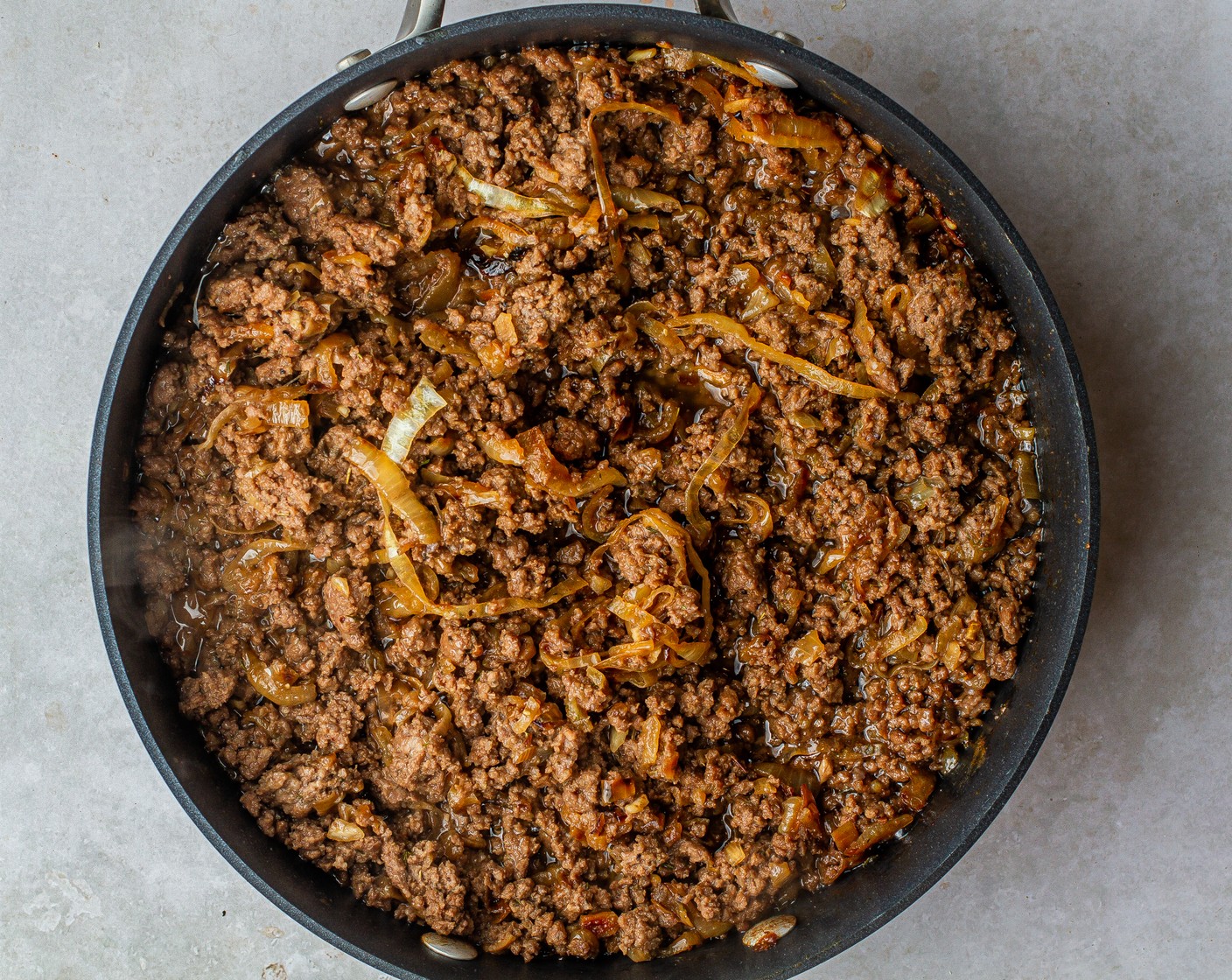 step 4 Add beef to the skillet, increase heat to medium and stir to break up the meat. Once browned, drain off excess grease.