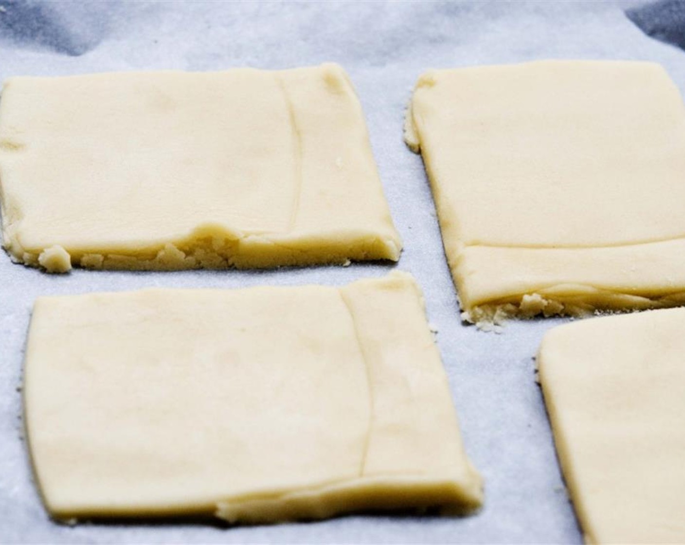 step 5 On a slightly floured surface, roll out the dough to a 0.5-centimeter thickness, and cut out 3-centimeter by 2-centimeter rectangles to make a flag shape. Place on a baking sheet and refrigerate for 20 to 30 minutes.