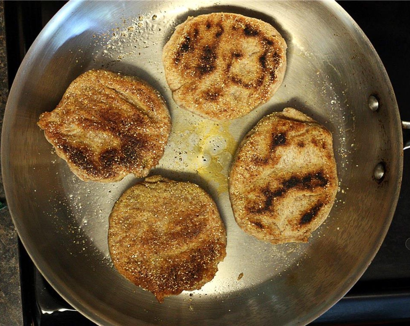 step 10 Flip the muffins over and press down on them gently with the back of the spatula. Cook for another 8 minutes. Repeat with remaining muffins, adding shortening before each batch.