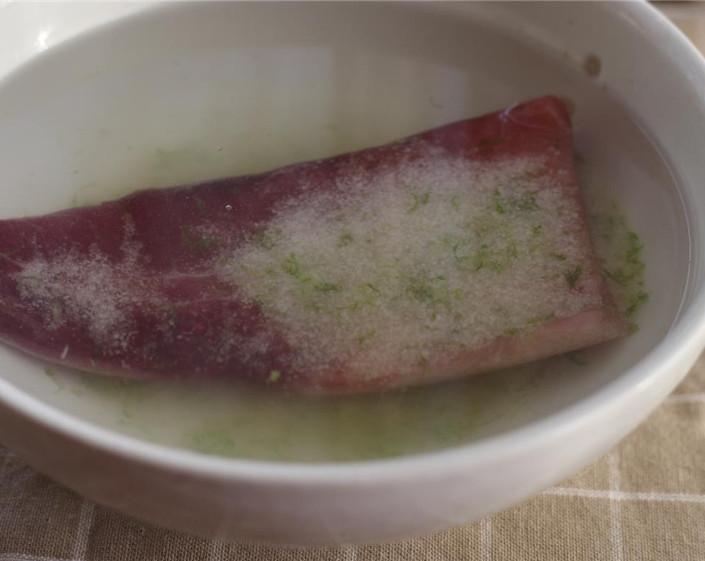 step 11 When hamachi is finished curing, soak the cured fillets in a bowl of cold water for 2 minutes.