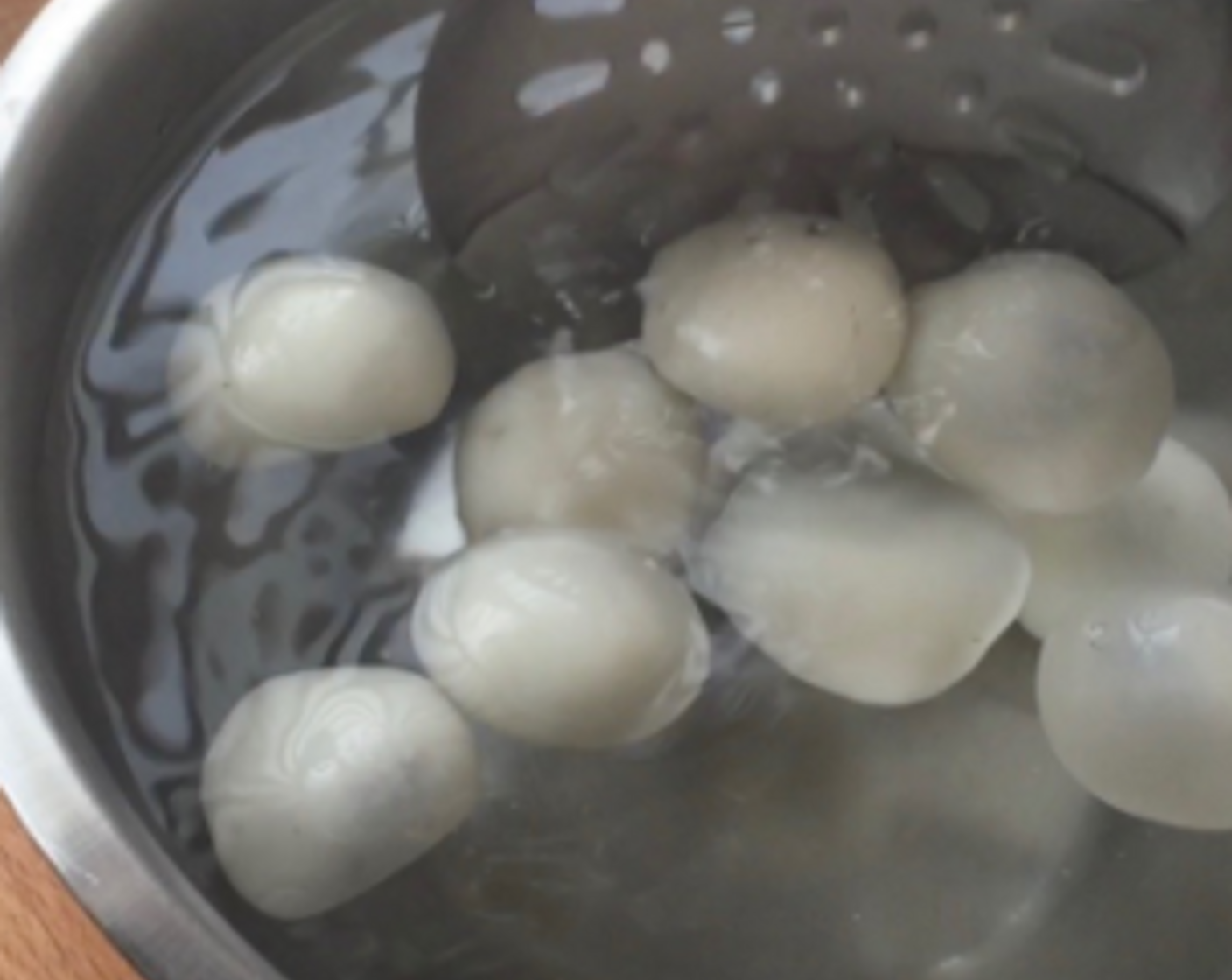 step 25 Sieve out all the cooked glutinous rice balls and place them into a bowl of cold water for about 1 minute. This process will make the rice balls more chewy.