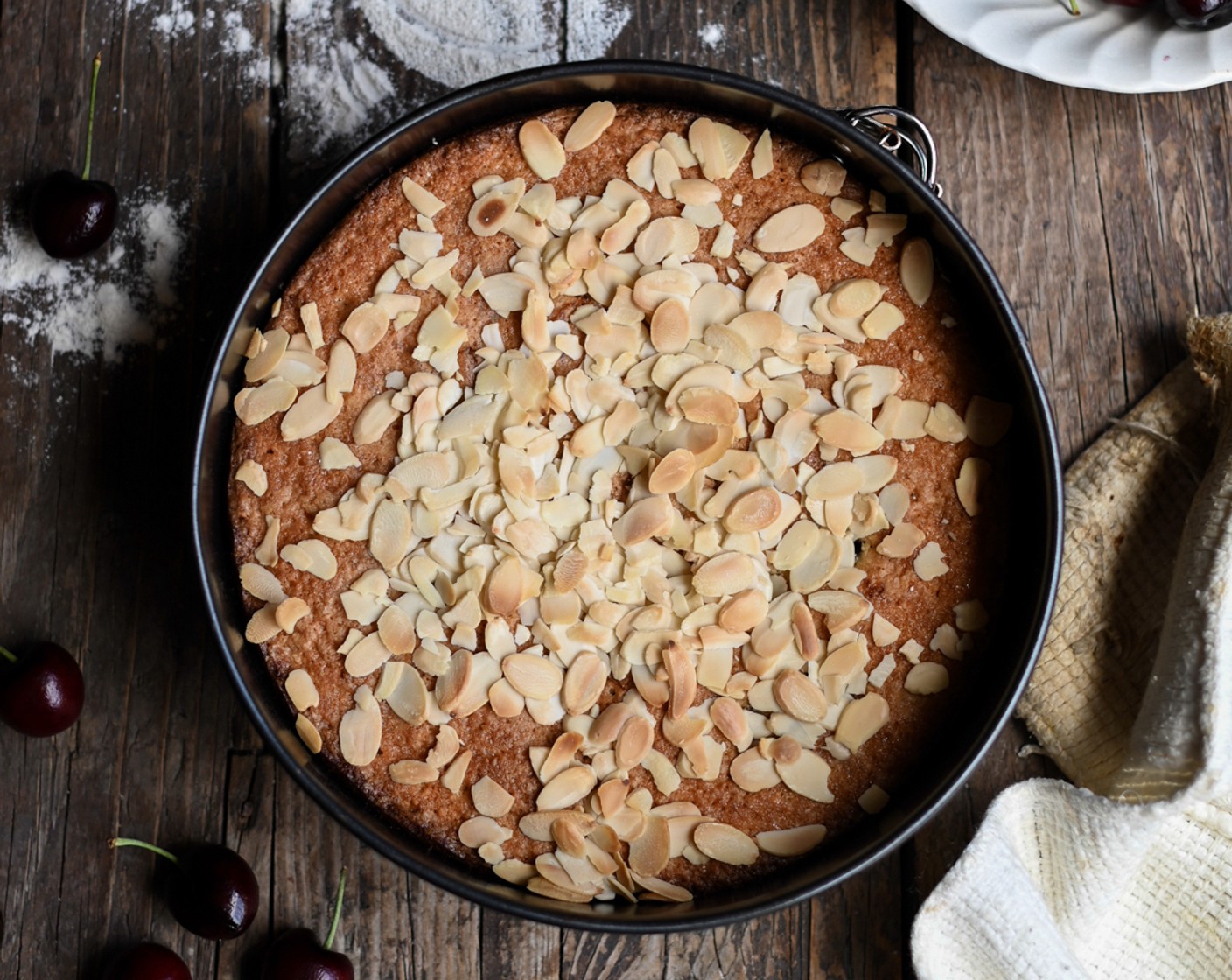 step 6 Remove the cake from the oven, sprinkle over the Sliced Almonds (1/2 cup) and return the cake to the oven for a further 10 minutes. The cake is cooked once a skewer inserted into the center comes out clean.