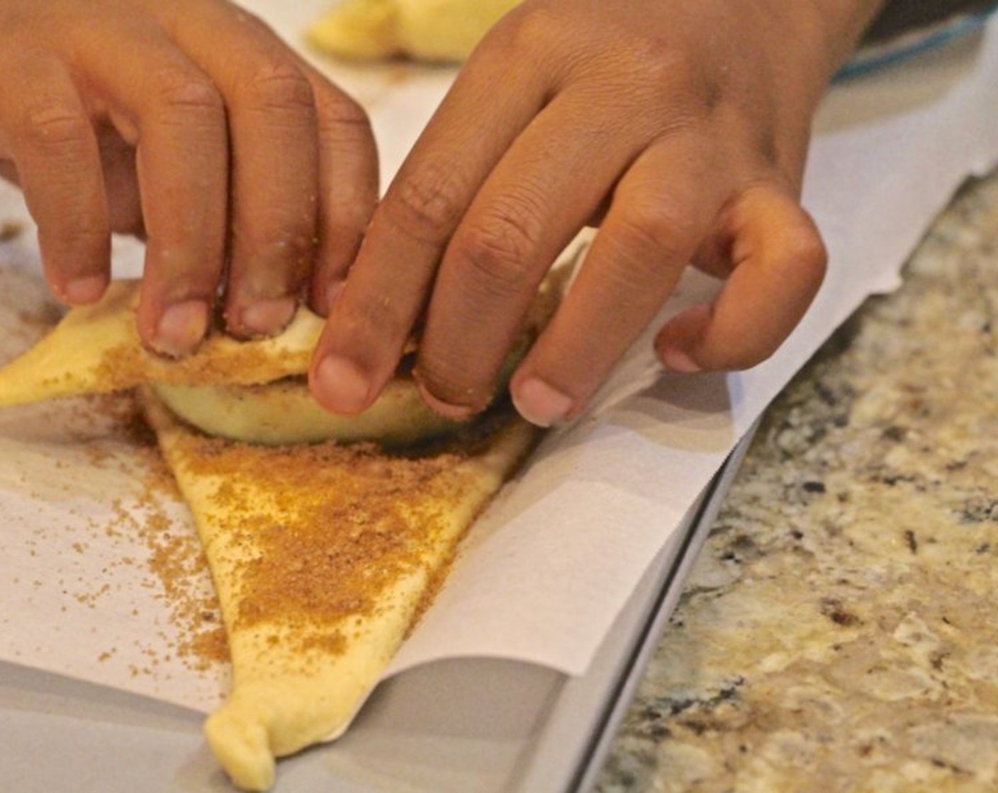 step 7 Starting at the wide end of each triangle, roll the apple in the crescent dough.