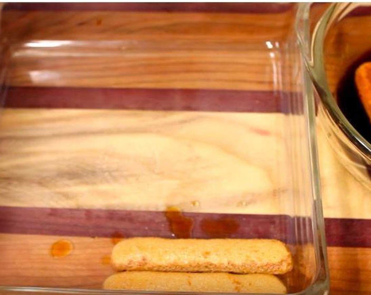 step 5 To assemble the tiramisu, dunk Ladyfingers (7 oz) into espresso mixture for 2-3 seconds and line the bottom of a 9"x9" baking dish with them.