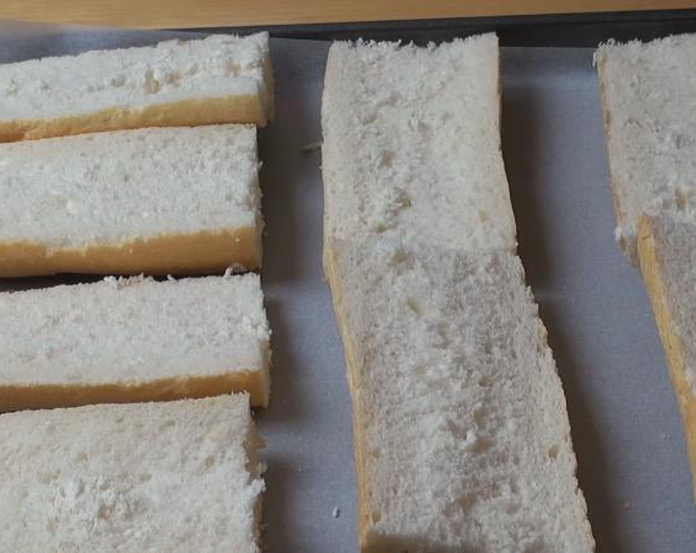 step 1 Cut French Bread (1) into 4 even pieces and slice each in half. Arrange the 8 half subs on a baking tray lined with non-stick baking paper. Set aside.