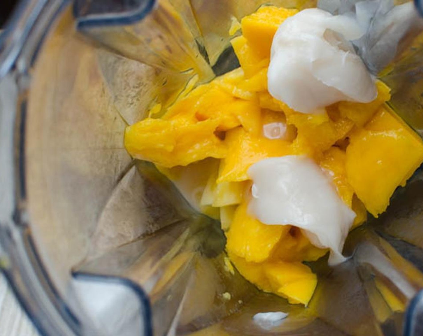 step 1 Combine the Fresh Pineapple Chunks (300 g), Mango (1), Dark Rum (2 Tbsp), and Cream of Coconut (2 Tbsp) in a blender.