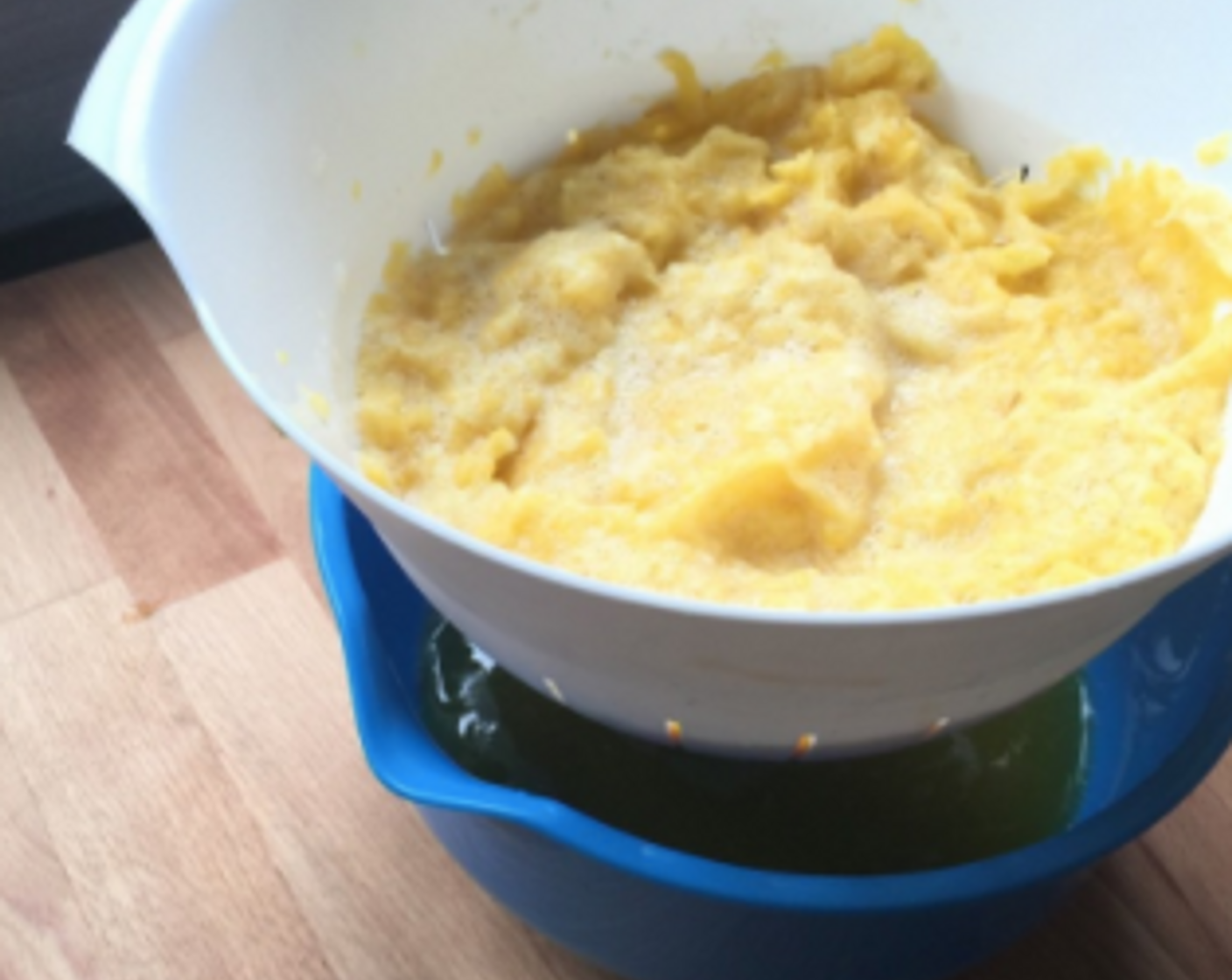 step 11 When finished grating, drained the grated pineapples in the strainer. Safe the pineapple juice in the plastic bowl for later use.