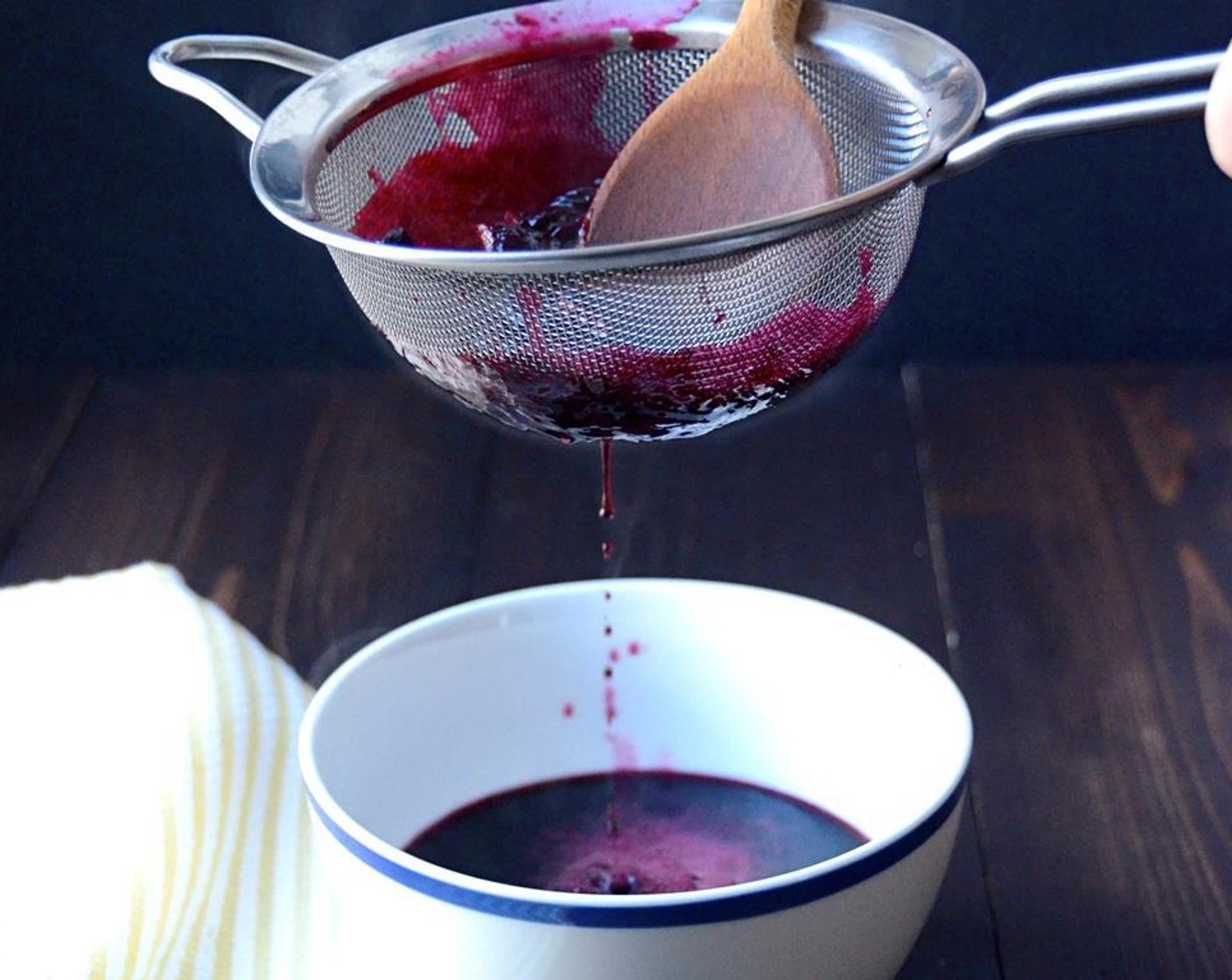 step 3 Set a fine mesh strainer over a small bowl. Pour the blueberry sauce through the strainer. Use the back of a wooden spoon to press on the blueberry solids, pushing them through the strainer. Do this until the only thing left in the strainer are the blueberry skins and the lemon rinds. Discard the solids. Cover and refrigerate the blueberry puree.