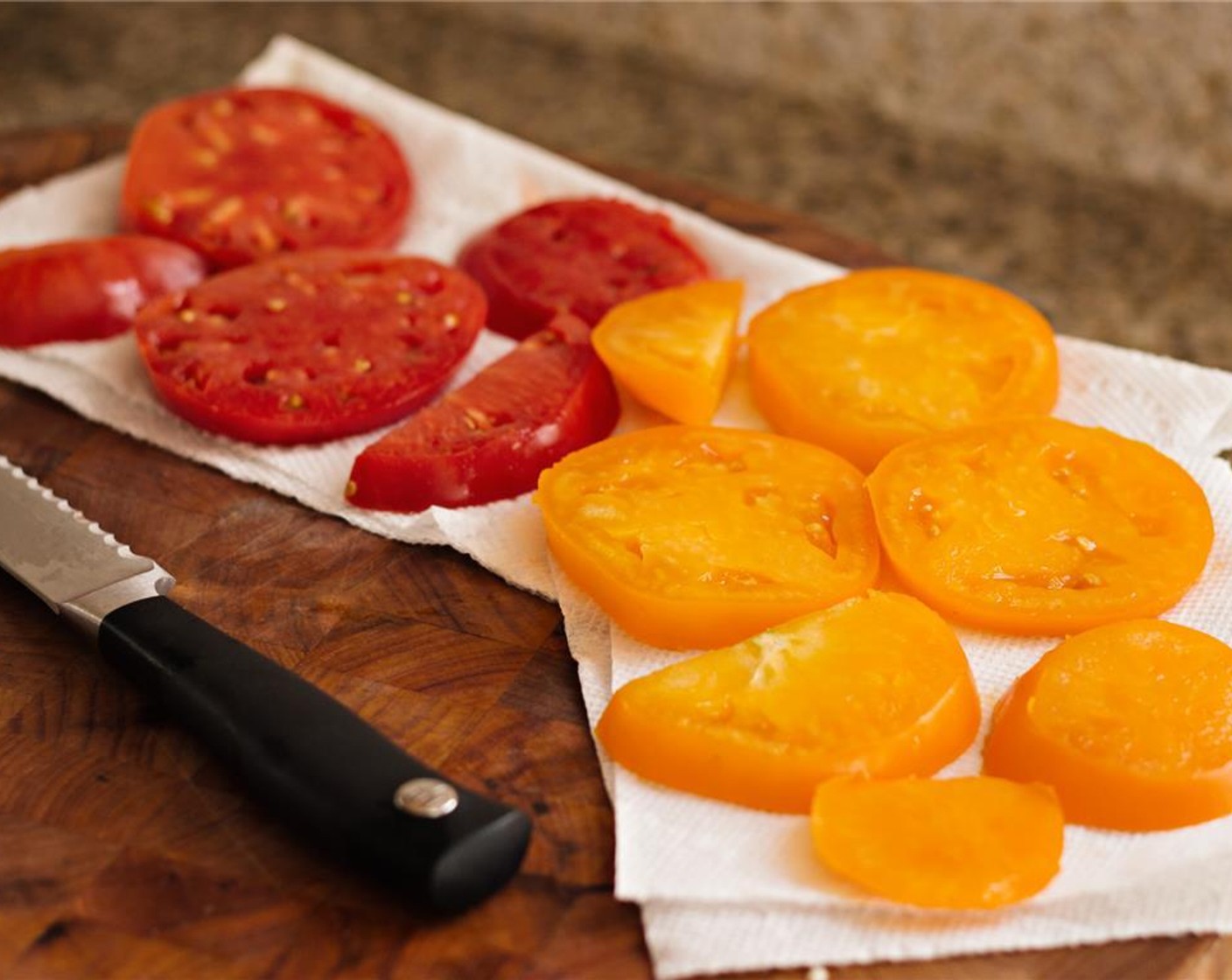 step 10 Slice the Heirloom Tomatoes (2) into 1/4 inch discs and drain on paper towels to remove excess moisture.