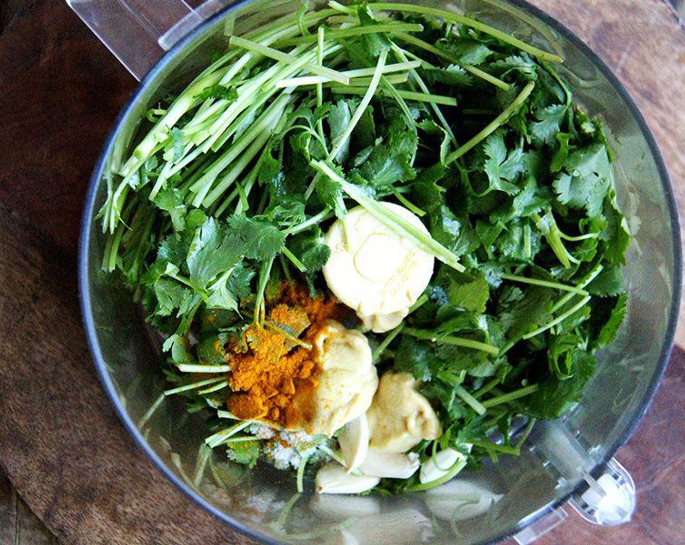 step 1 Place the Fresh Cilantro (7 cups), juice from Limes (2), Olive Oil (4 Tbsp), Garlic (1 clove), Dijon Mustard (2 tsp), Granulated Sugar (2 tsp), Ground Turmeric (1/2 tsp), Salt (1/4 tsp), and Freshly Ground Black Pepper (to taste) in a food processor or blender.