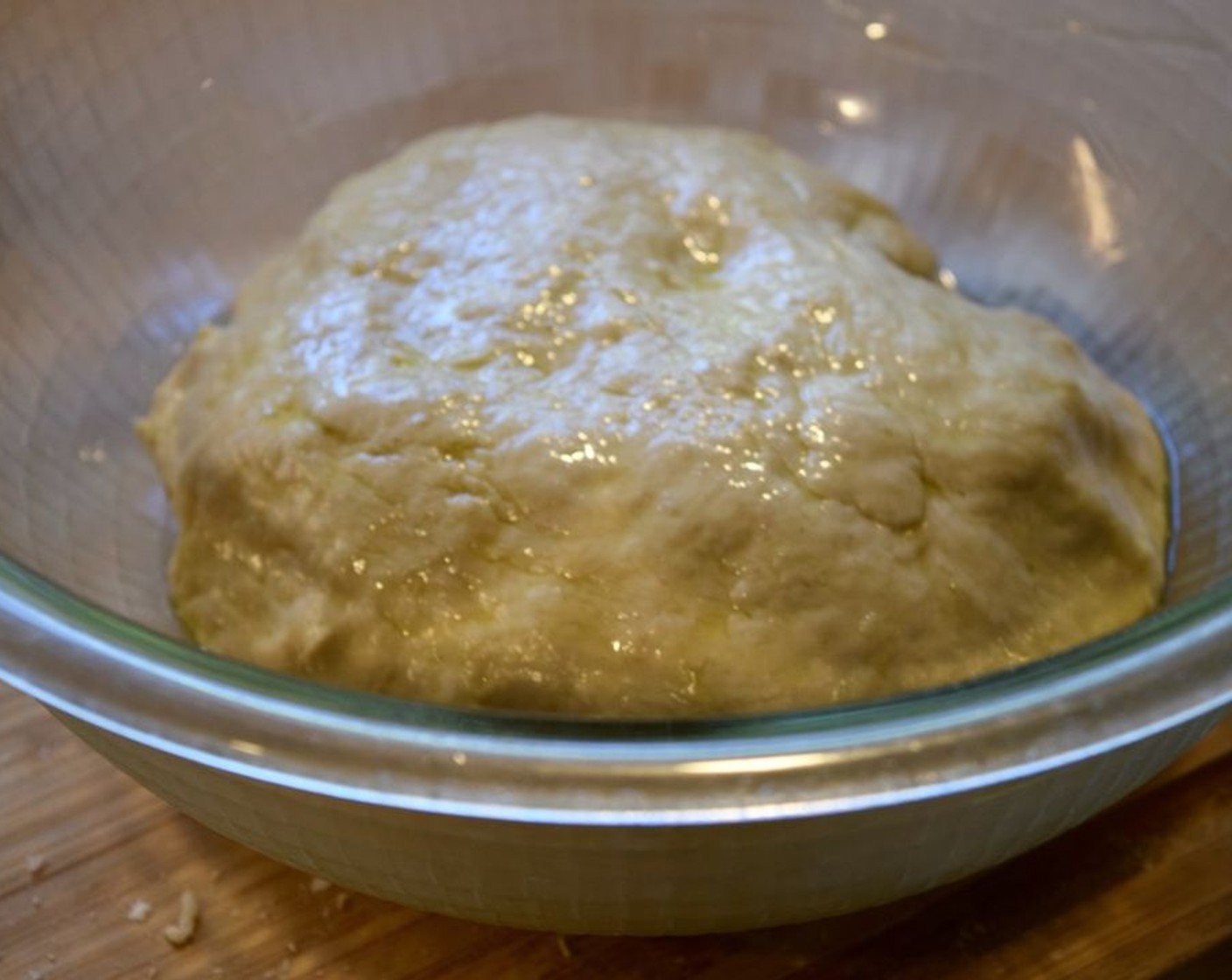 step 5 To a medium-large sized bowl, add a drizzle of olive oil at the bottom and take your dough ball and coat it in the olive oil.