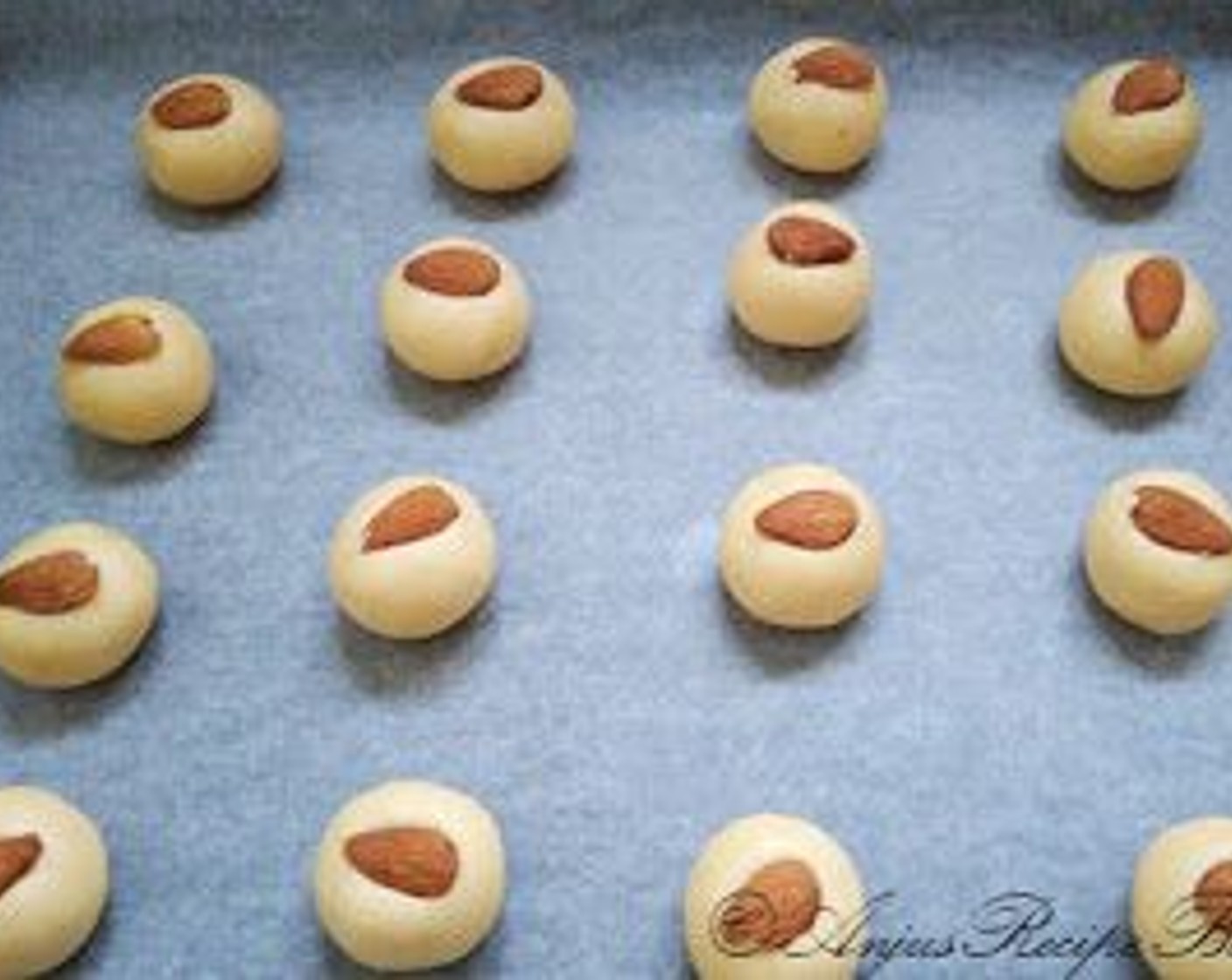 step 10 Place an Almonds (to taste) on each cookie and slightly press the nut on to the dough ball.