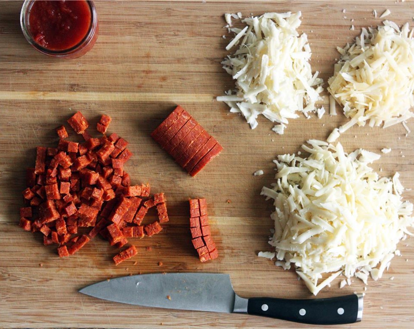 step 1 Chop the whole stick of Pepperoni Sausage (6 oz) into small cubes. Grate the Mozzarella Cheese (1 cup), Asiago Cheese (3 2/3 Tbsp), and Parmesan Cheese (1/3 cup).