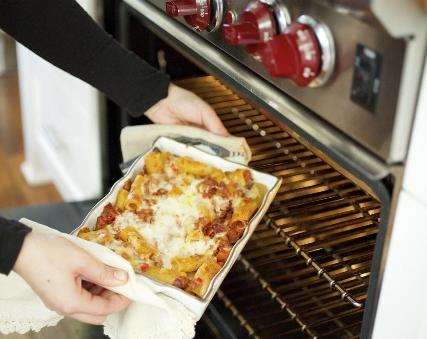 step 17 Serve the baked rigatoni family-style, in the baking dish. Offer the garlic bread wrapped in a colorful cloth napkin in a basket or on a plate. Serve and enjoy!