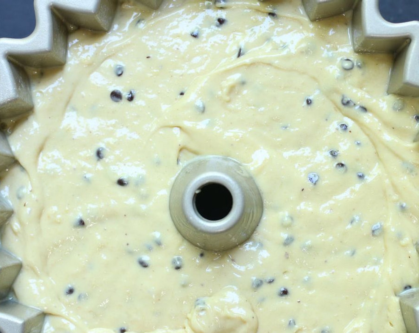 step 4 Pour the cake batter evenly into the prepared bundt pan, smoothing the top gently.