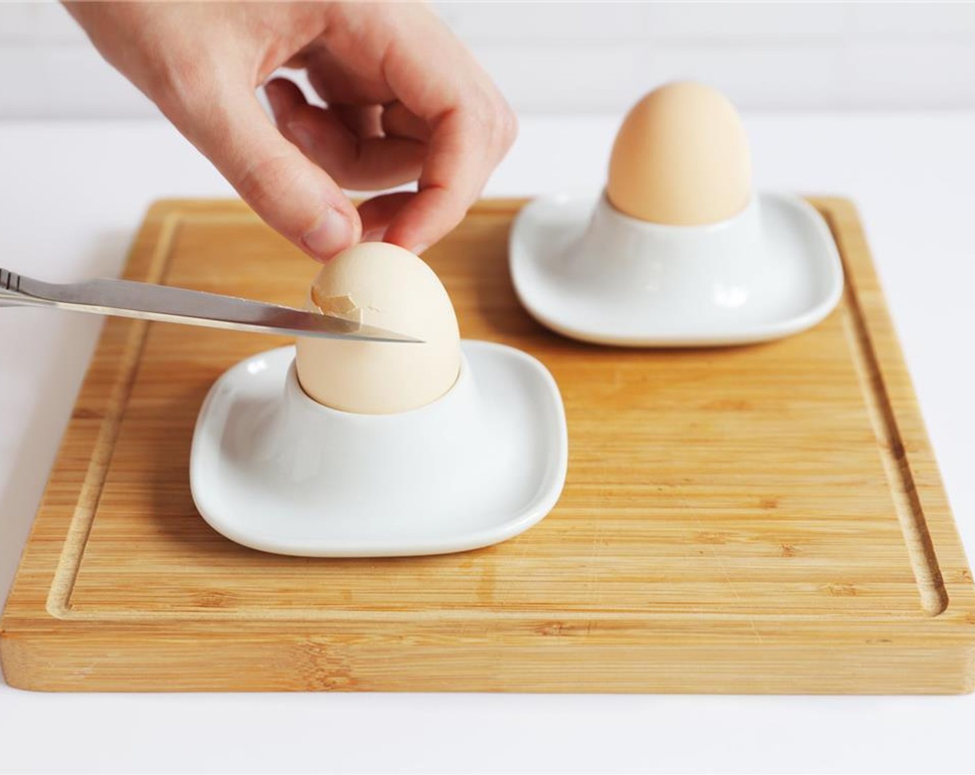 step 4 Gently remove eggs, slice off the top, and serve immediately.