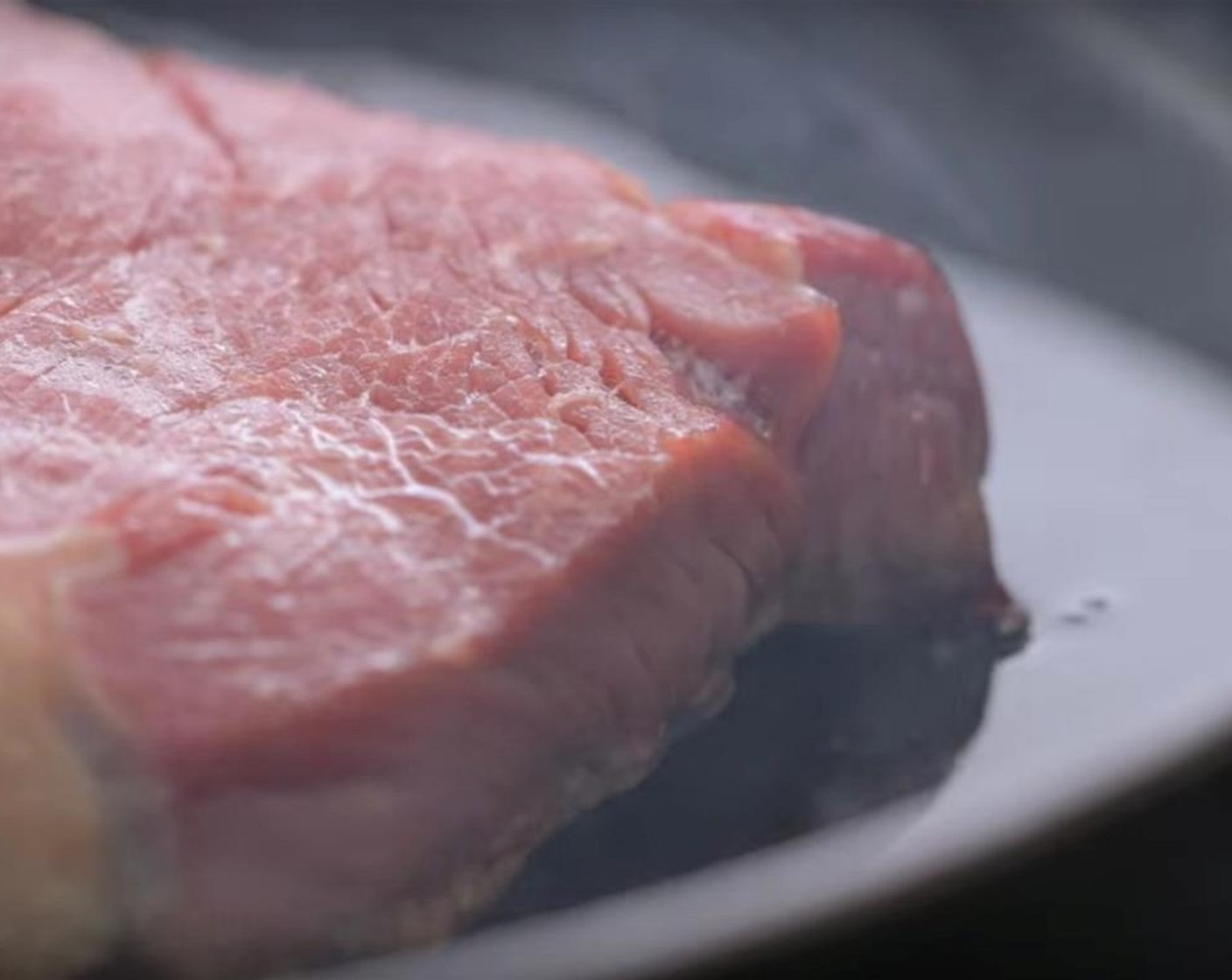 step 2 Preheat the oven to 350 degrees F (180 degrees C). Bring the New York Strip Steak (2) to room temperature (steaks should be about 1-inch thick). Heat a cast iron pan until smoking hot over high heat on the stove. Carefully brush the pan with the Vegetable Oil (1 tsp).