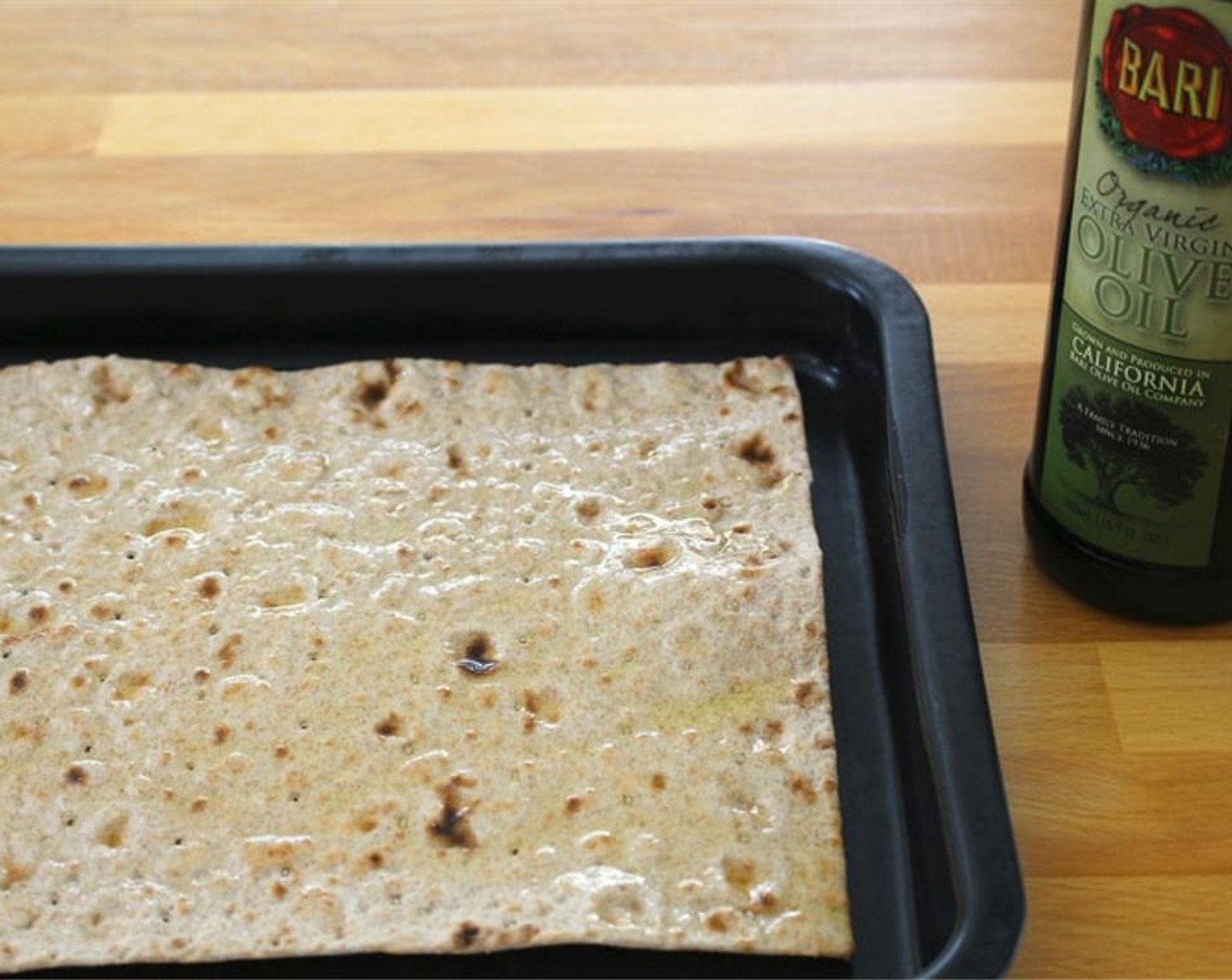 step 2 Top the Lavash (1) with Olive Oil (1 tsp) and brush over surface. Sprinkle with Salt (to taste). Top with Apple (1), Dried Rosemary (1/4 tsp), Ground Black Pepper (to taste), and Cheddar Cheese (1/4 cup).