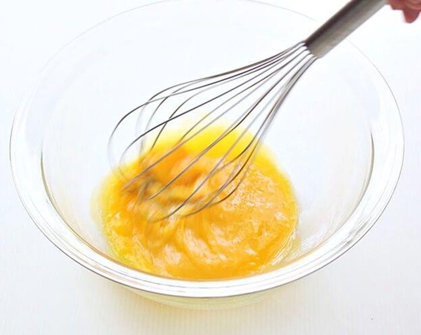 step 7 In a large bowl, stir well 3 egg yolks, Vanilla Extract (1/2 tsp), and Caster Sugar (2 Tbsp) with a hand whisk. Add grated apple and Corn Oil (2 2/3 Tbsp), stir well again to combine. Sift in Cake Flour (1/2 cup) and mix well.