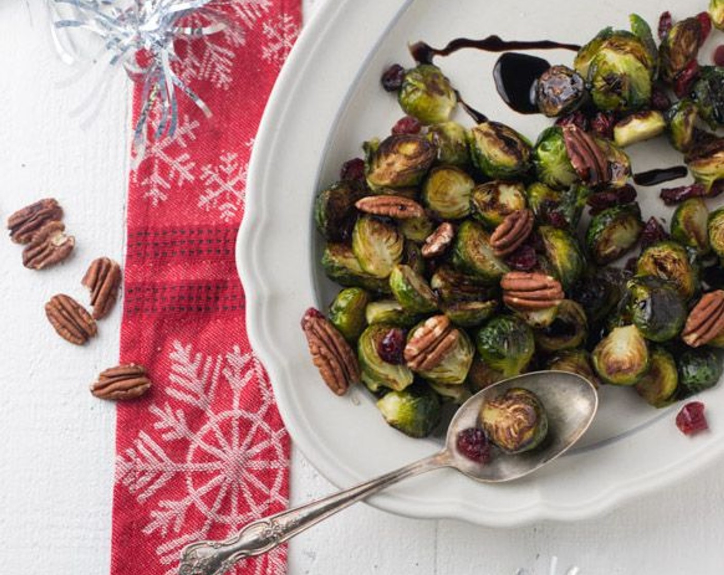 step 6 Combine the brussels sprouts, pecans, and Dried Cranberries (1/4 cup) on a serving platter. Drizzle with the Balsamic Glaze (1 Tbsp).