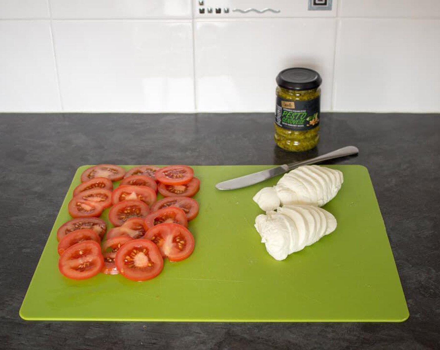 step 3 Meanwhile, slice the Tomatoes (2) and Fresh Mozzarella Cheese Ball (2).