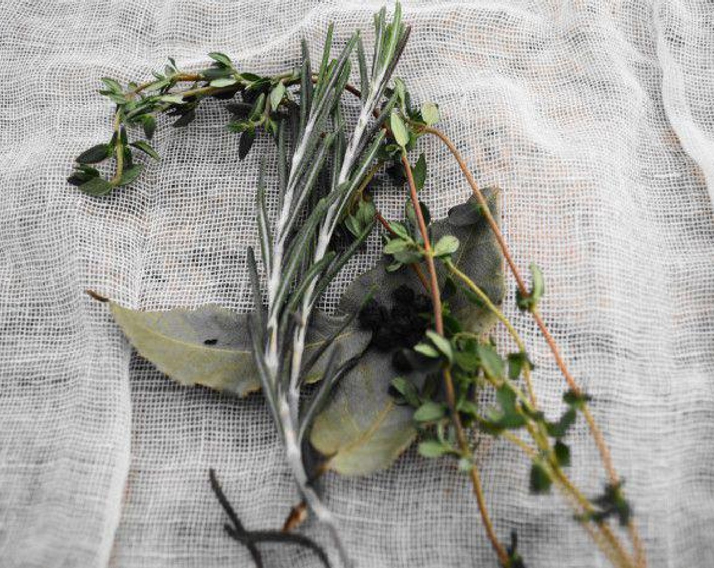 step 1 First, put together the herb bundle to really flavor the marinara sauce. Cut a big piece of cheesecloth and layer the Bay Leaves (2), Fresh Thyme (2 sprigs), Fresh Rosemary (2 sprigs), and Black Peppercorns (10) on it. Gather up the bundle tightly and tie it tightly with kitchen twine to hold it together.