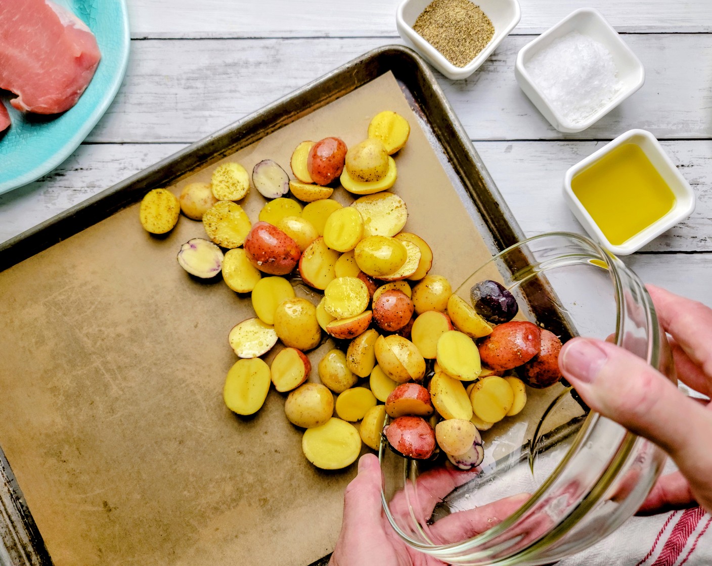 step 3 Pour out the seasoned little potatoes over half of the sheet pan and set aside.