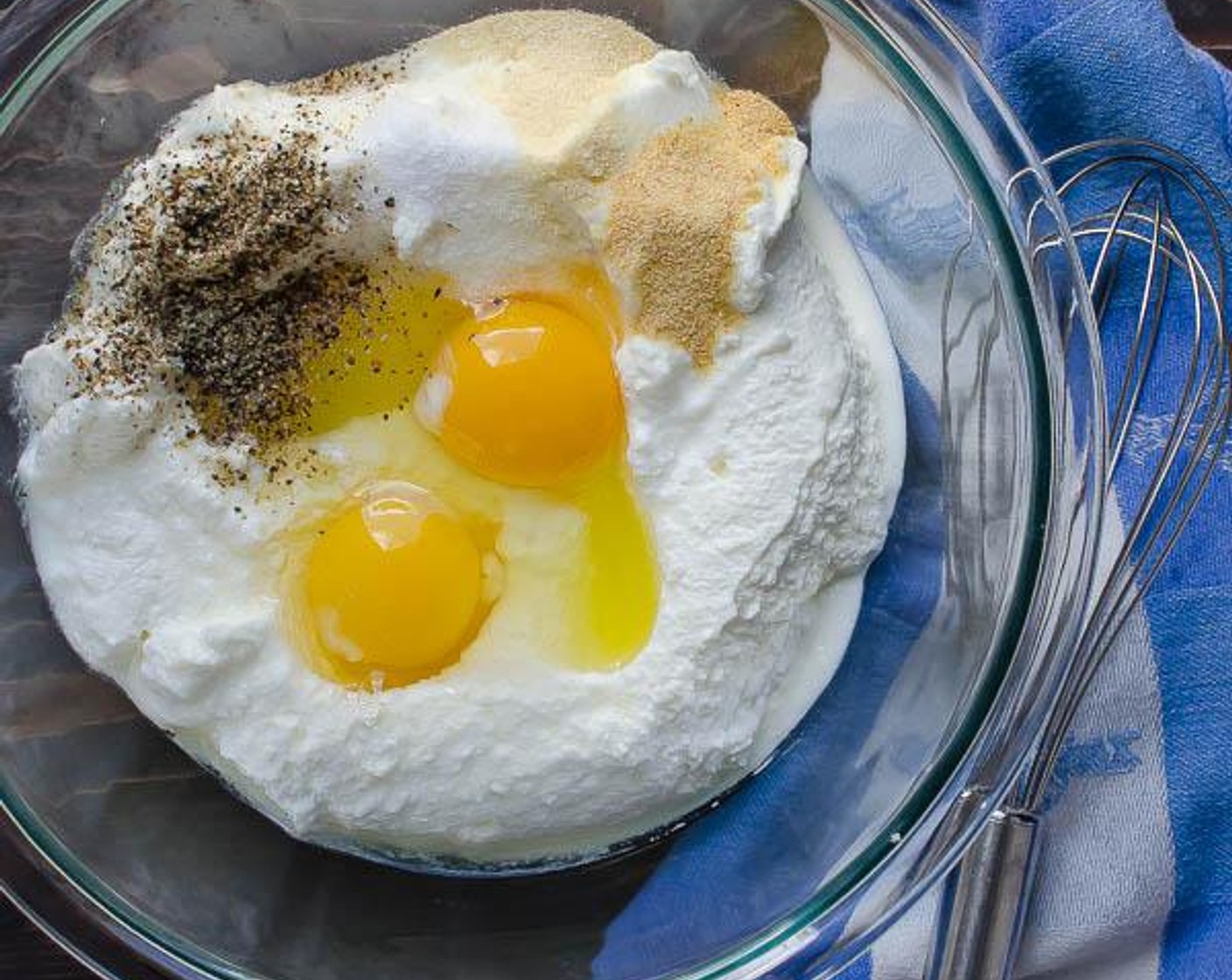 step 5 In a medium bowl, combine the Part-Skim Ricotta Cheese (3 2/3 cups), Eggs (2), Kosher Salt (1 tsp), Ground Black Pepper (1/2 tsp), McCormick® Garlic Powder (1/2 tsp), Onion Powder (1/2 tsp), and 1 cup of Parmigiano-Reggiano (1 cup).